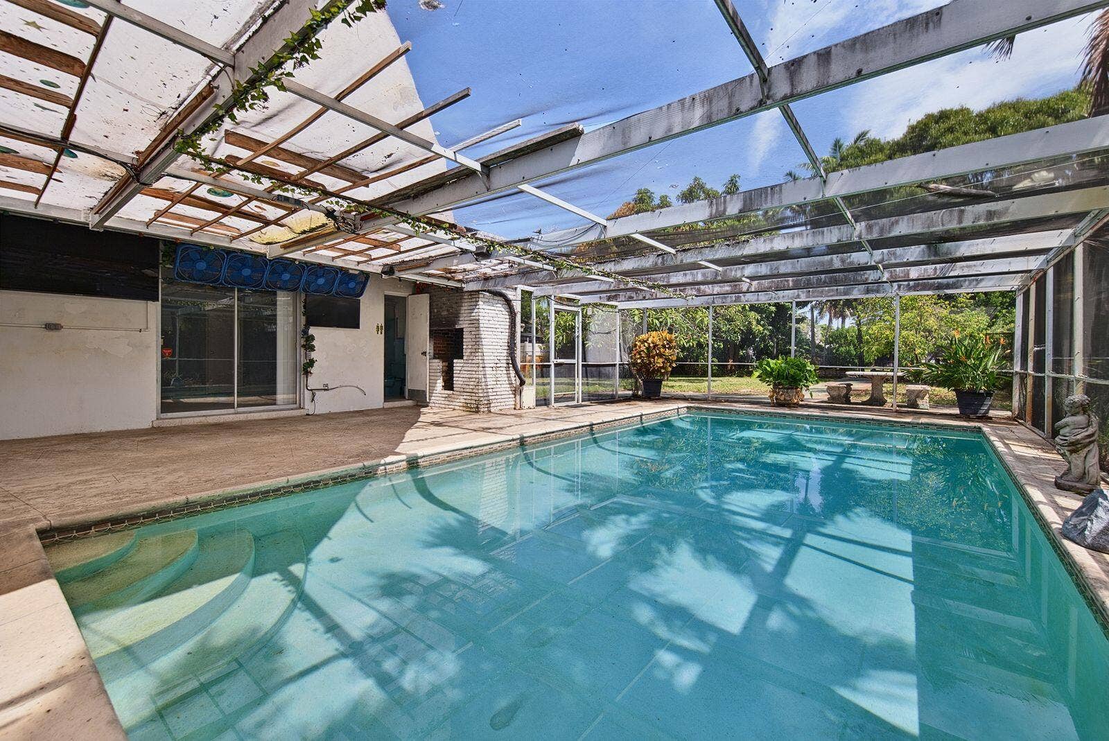 201 NE 29th Street, Wilton Manors, FL 33334 Screened pool area features generous deck space and a covered patio adjoining the residence.