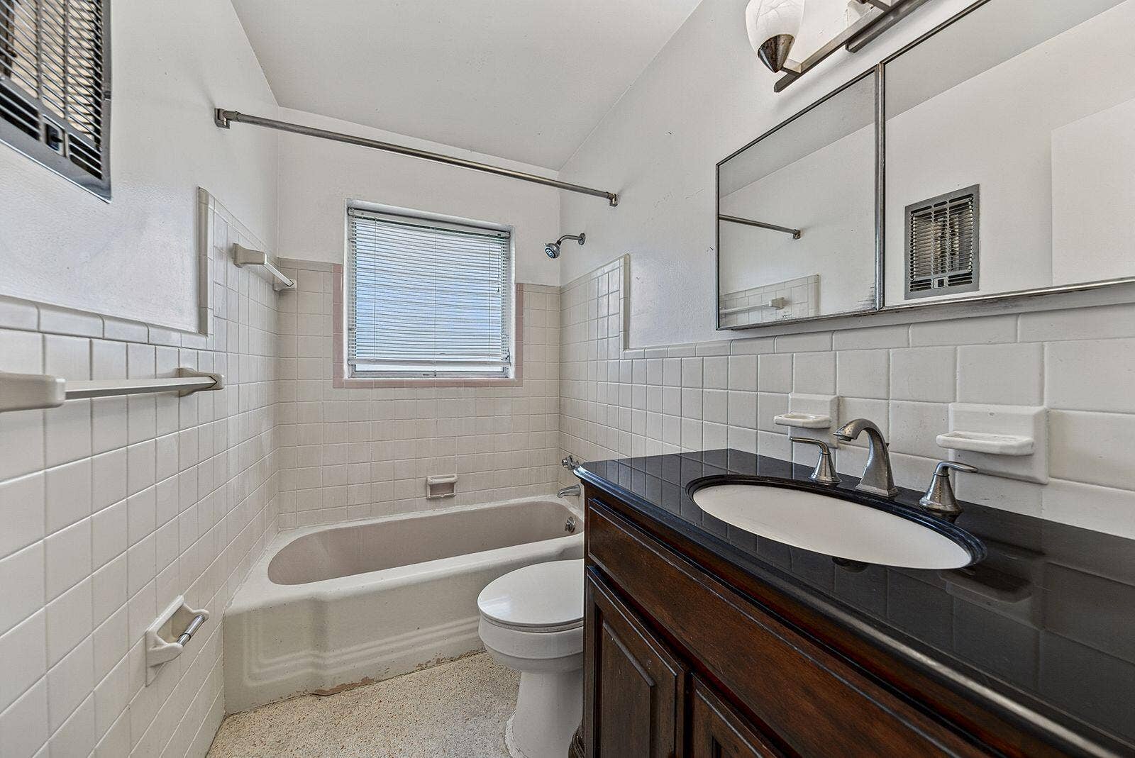 201 NE 29th Street, Wilton Manors, FL 33334 Full bathroom with tub-and-shower combination, tiled walls and a dark countertop vanity.