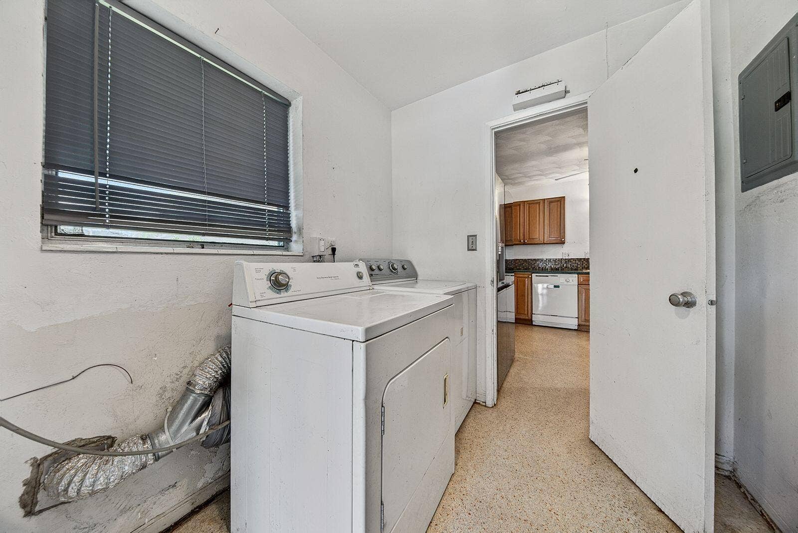 201 NE 29th Street, Wilton Manors, FL 33334 Dedicated laundry area with full-size washer and dryer, conveniently located adjacent to the kitchen.
