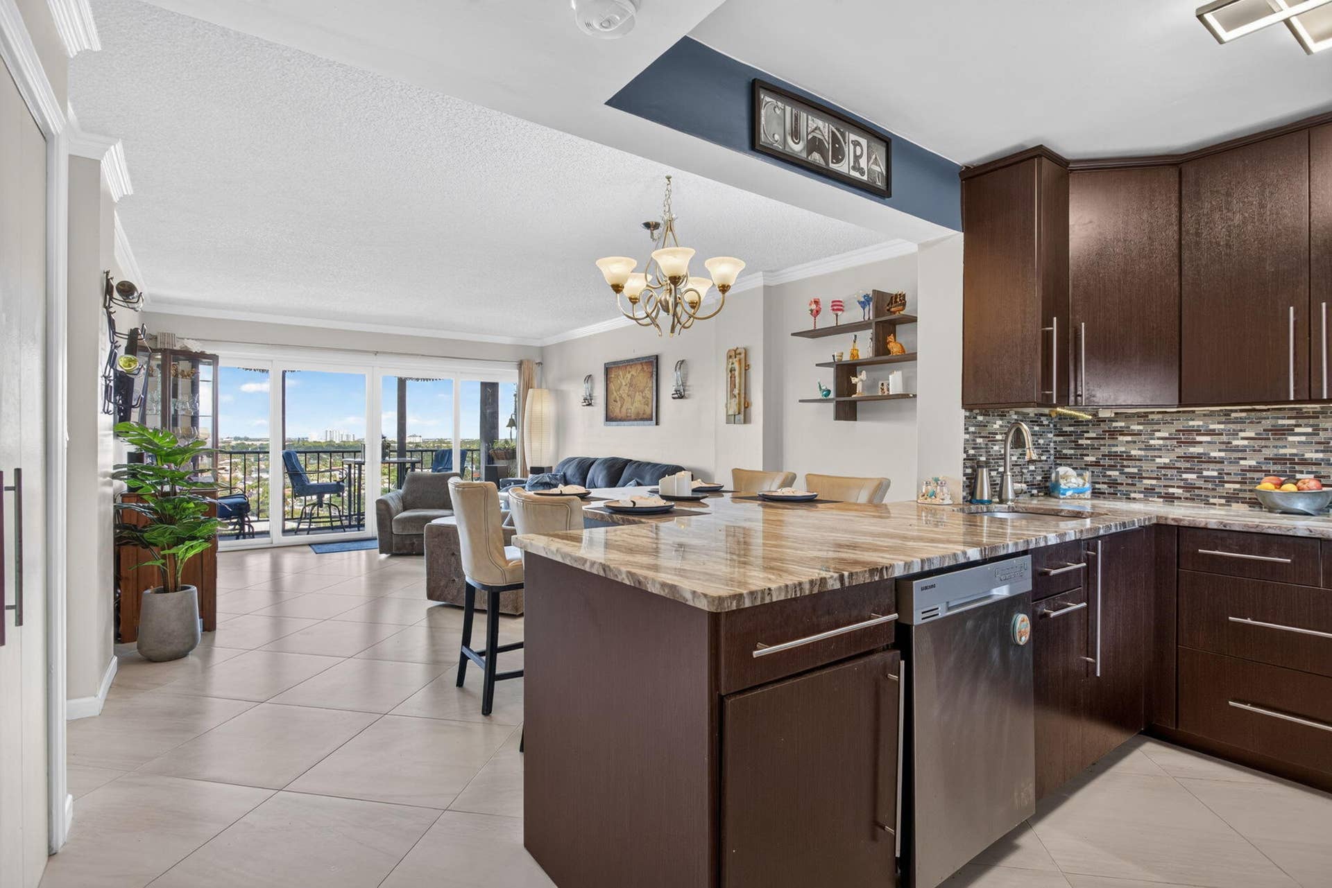 801 S Federal Highway, #1103, Pompano Beach, FL 33062 Kitchen with dark wood-finish cabinetry, light-toned tiled flooring, and a stone-finish countertop