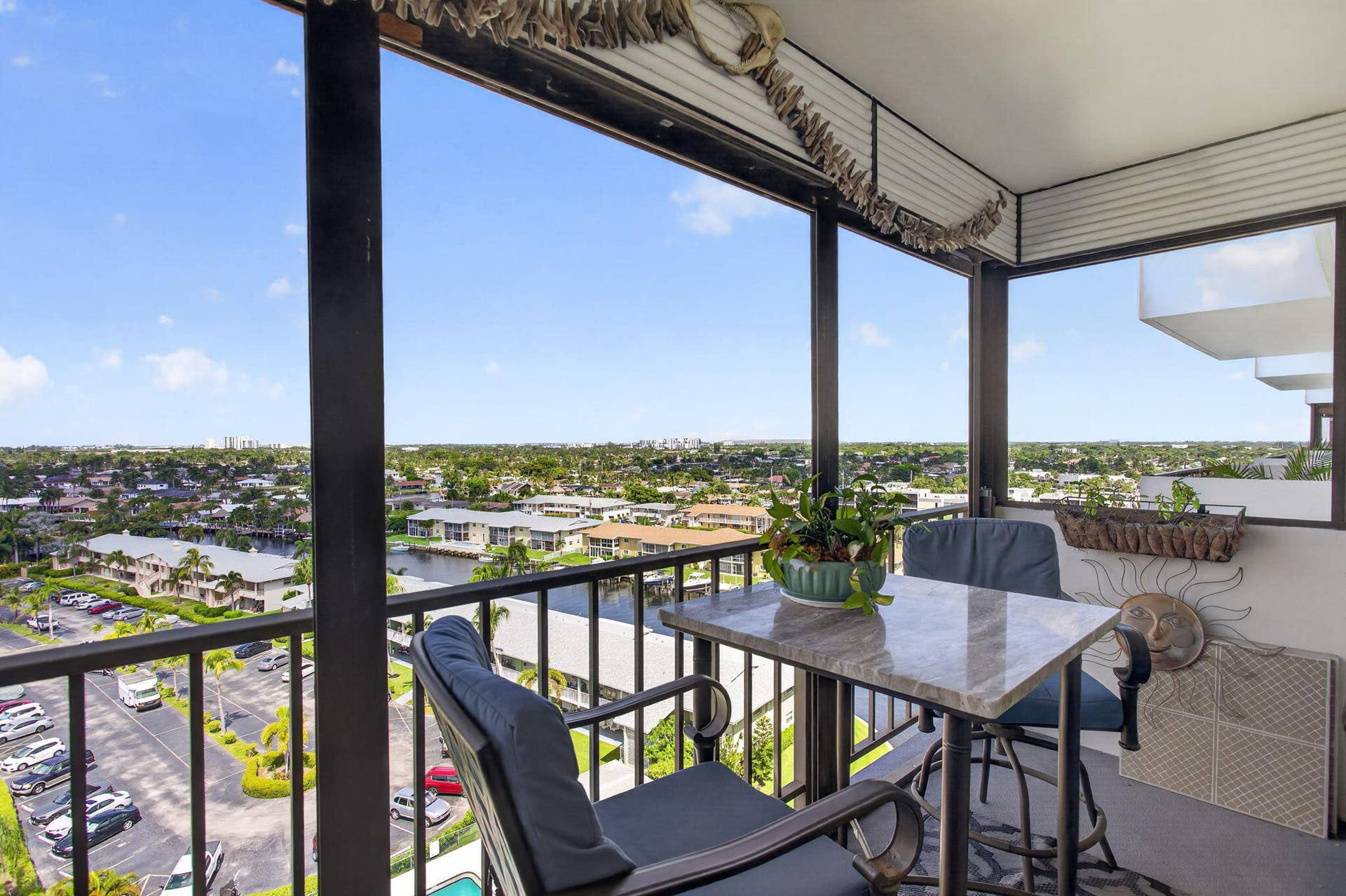 801 S Federal Highway, #1103, Pompano Beach, FL 33062 Balcony featuring a metal railing, high-top table with a stone-finish surface, and a water-canal backdrop