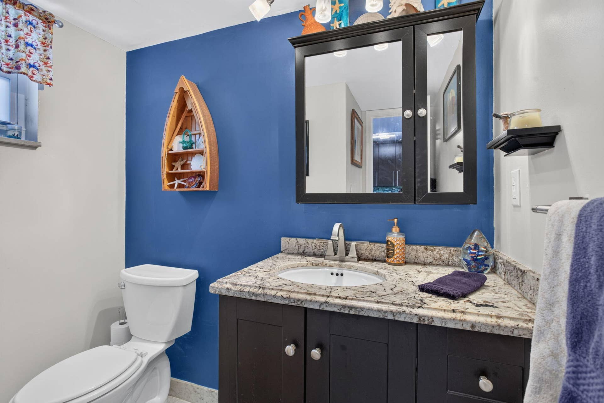 801 S Federal Highway, #1103, Pompano Beach, FL 33062 Corner vanity with a granite countertop, built-in sink, and dark wood-finish cabinetry