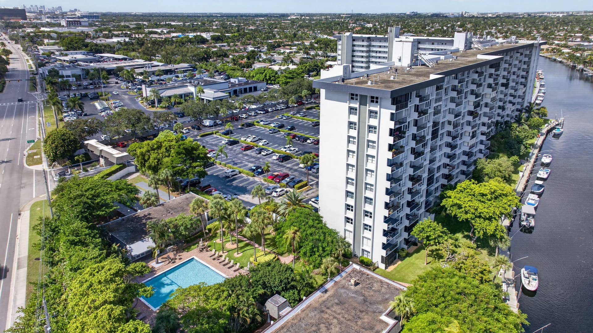 801 S Federal Highway, #1103, Pompano Beach, FL 33062 Waterfront multi-story building featuring individual balconies, a large outdoor swimming pool, and dedicated parking areas