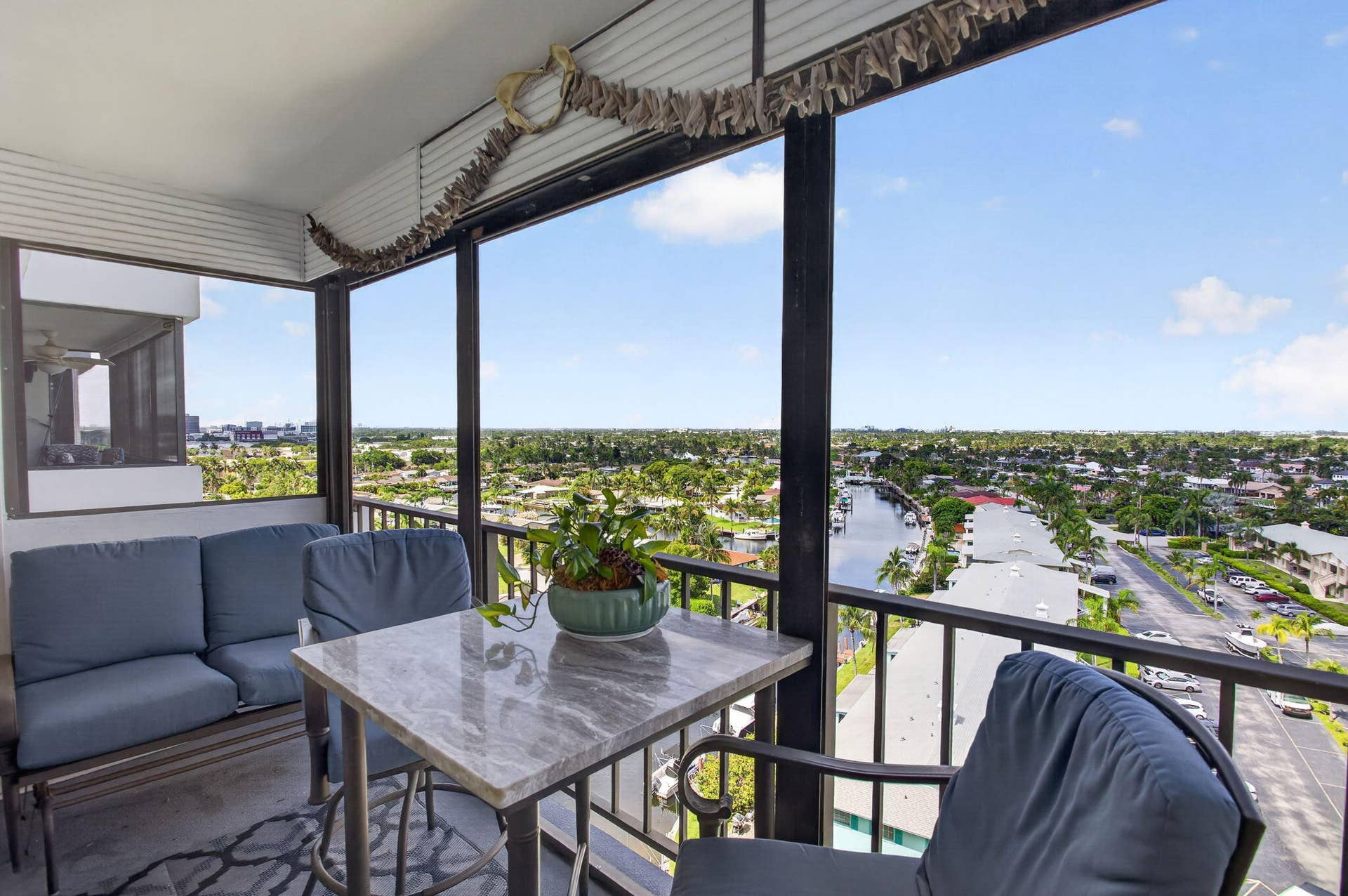 801 S Federal Highway, #1103, Pompano Beach, FL 33062 Screened balcony with high-rise perspective, featuring a durable tile floor and black metal railings