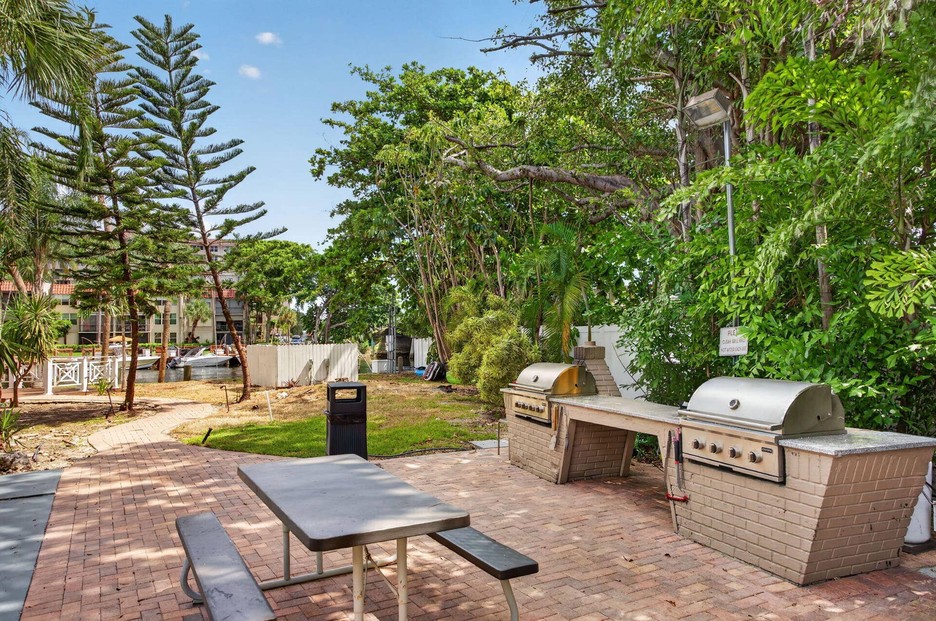 801 S Federal Highway, #1103, Pompano Beach, FL 33062 Outdoor grilling station with two built-in grills, brick pavers, and a picnic table