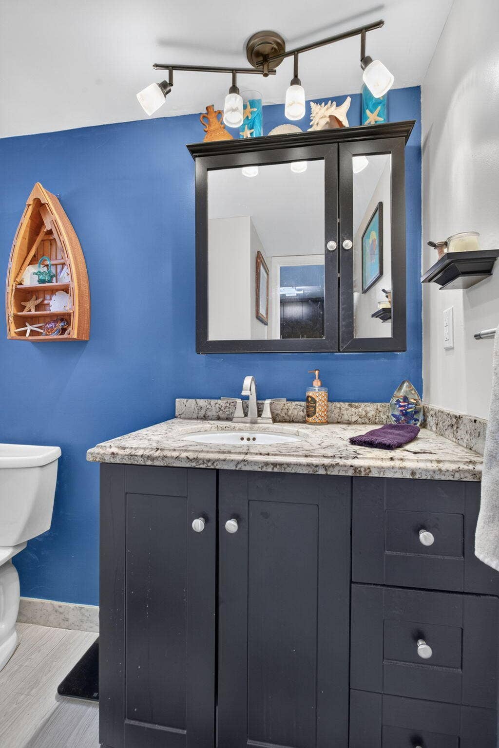 801 S Federal Highway, #1103, Pompano Beach, FL 33062 Vanity with a granite-style countertop, undermount sink, and dark wood cabinetry