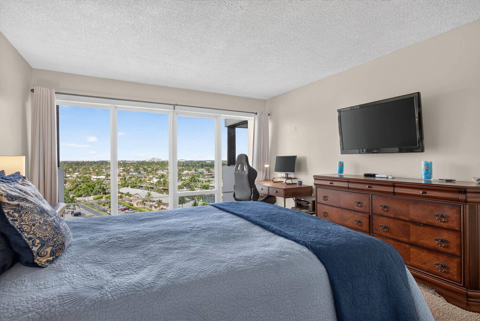 801 S Federal Highway, #1103, Pompano Beach, FL 33062 Expansive wall of windows with urban scenery, light-colored walls, and wood-finish flooring