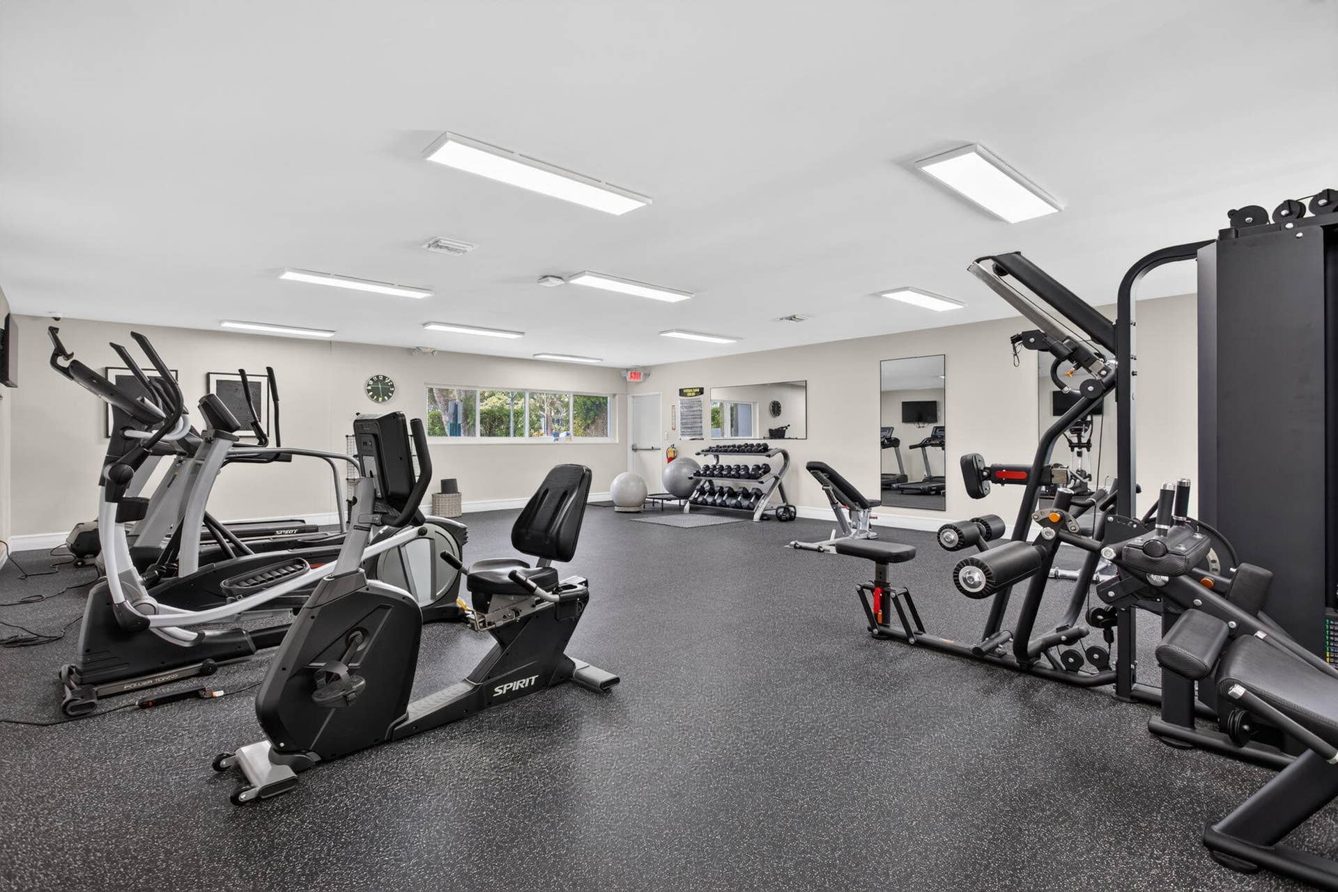 801 S Federal Highway, #1103, Pompano Beach, FL 33062 Spacious fitness room with rubber flooring, recessed lighting, expansive windows, and wall-mounted mirrors