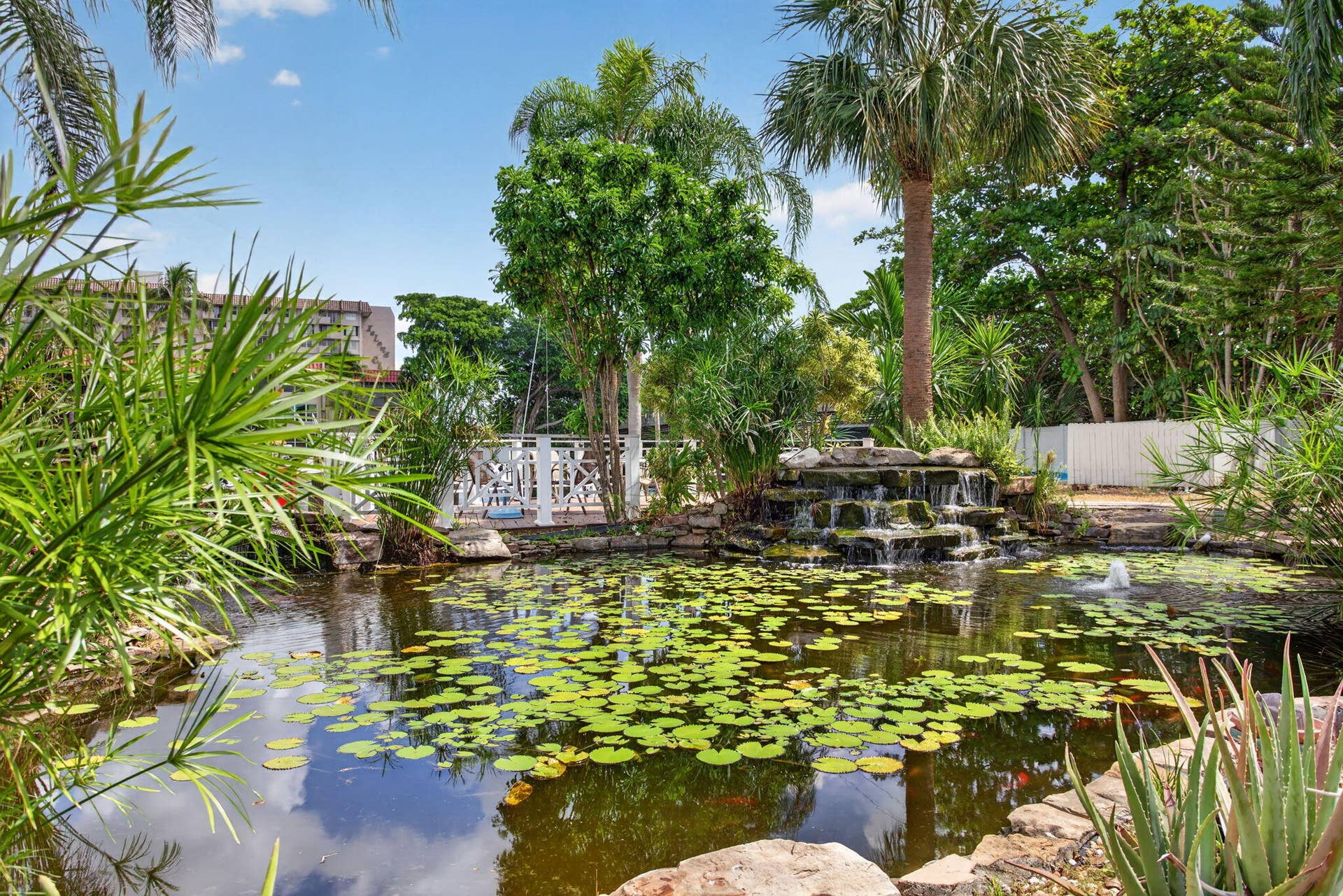 801 S Federal Highway, #1103, Pompano Beach, FL 33062 Expansive water feature with lush landscaping, a multi-tiered waterfall, and an ornamental bridge