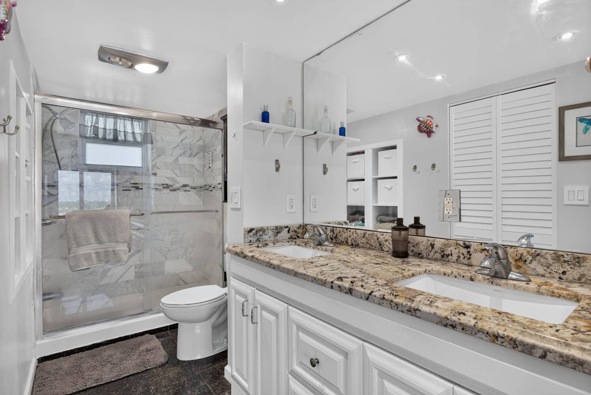 801 S Federal Highway, #1103, Pompano Beach, FL 33062 Double vanity with under-mount sinks, granite countertop, frameless mirror, and white paneled cabinetry