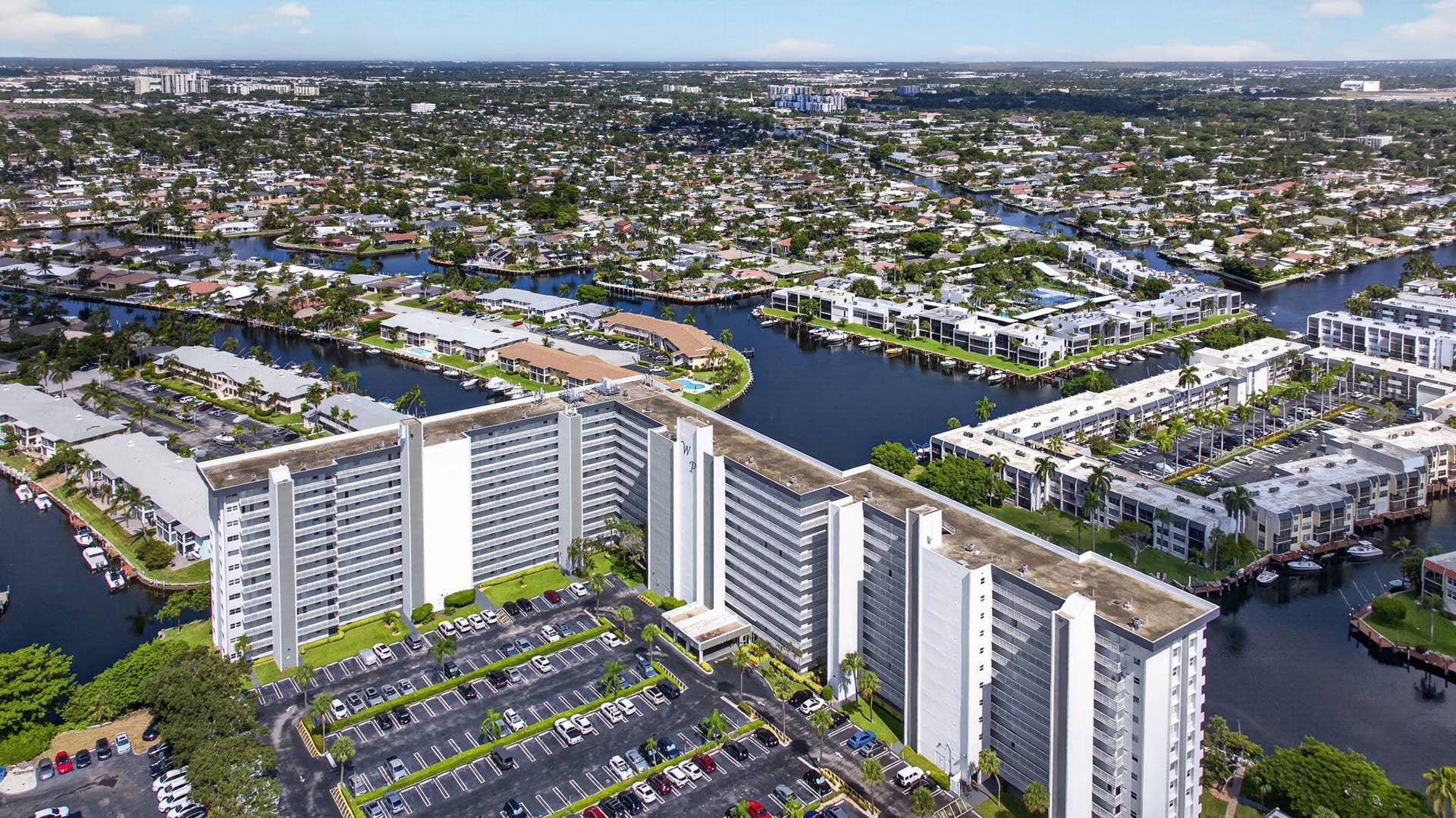 801 S Federal Highway, #1103, Pompano Beach, FL 33062 Canal-front community featuring multi-story residential buildings and extensive parking areas