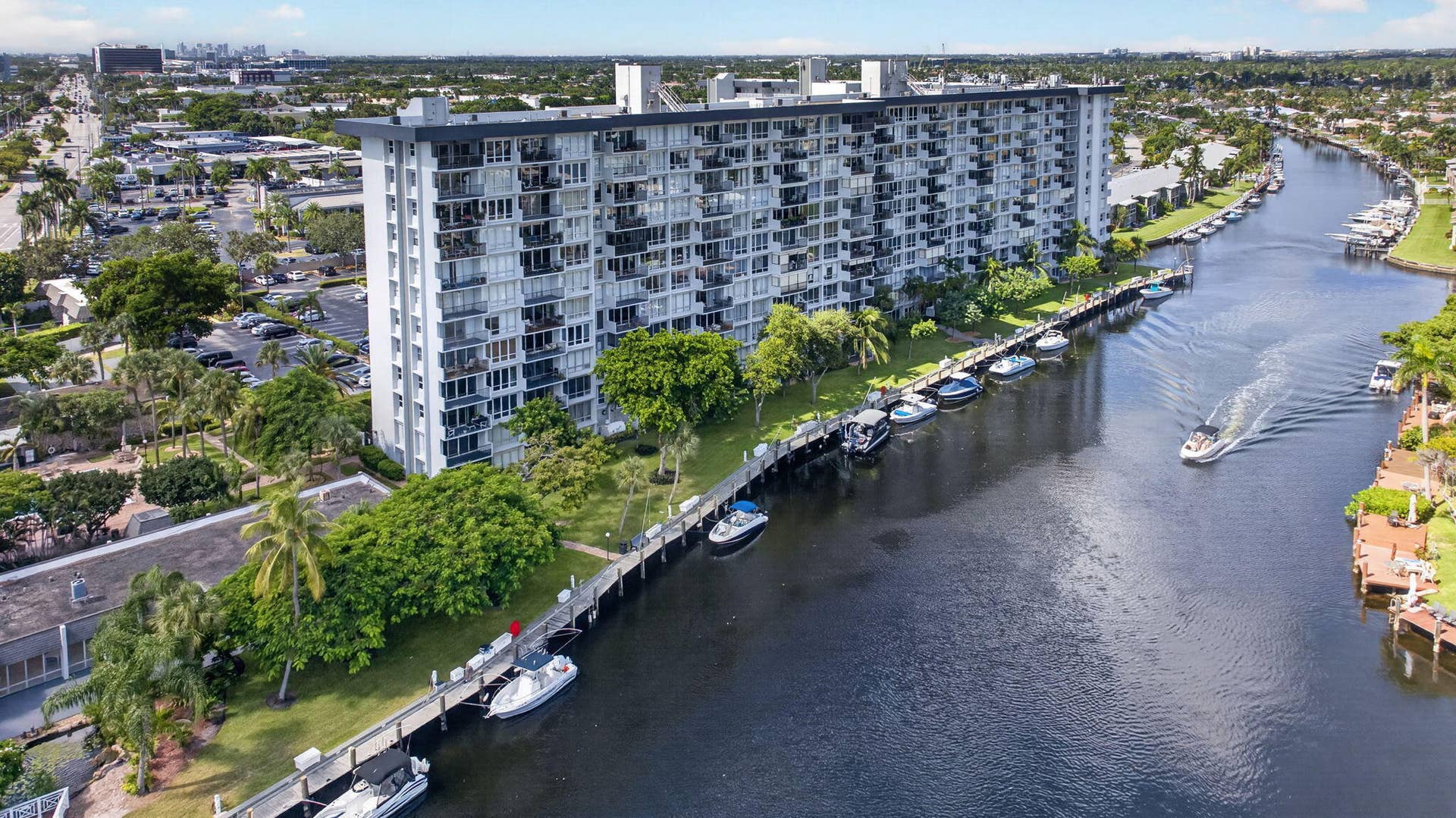 801 S Federal Highway, #1103, Pompano Beach, FL 33062 Multi-story building with multiple balconies, situated along a waterway with dock space, surrounded by mature landscaping