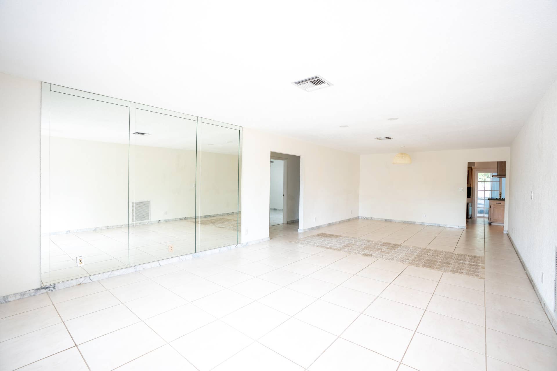 17 SE 8TH Terrace, Deerfield Beach, FL 33441 Spacious room featuring tile flooring, mirrored wall accents, a recessed ceiling light, and an overhead light fixture