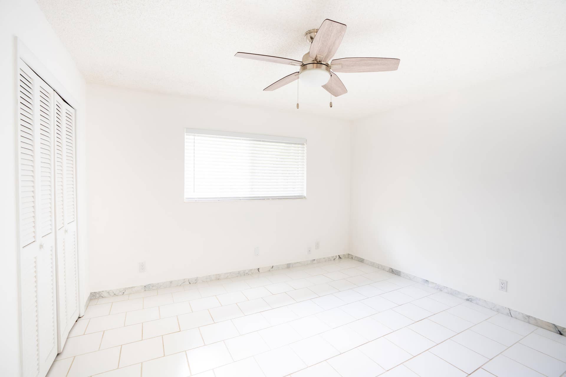 17 SE 8TH Terrace, Deerfield Beach, FL 33441 White tile flooring with a marble-finish border, white walls, and a window with horizontal blinds