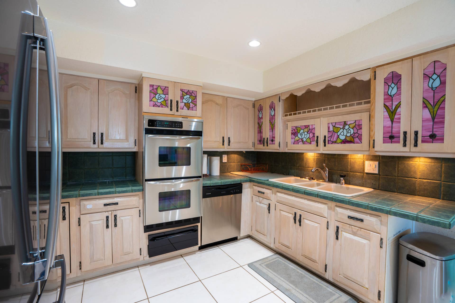 17 SE 8TH Terrace, Deerfield Beach, FL 33441 Stainless steel double oven, stainless steel refrigerator, stainless steel dishwasher, tile flooring, and custom cabinetry with stained glass inserts