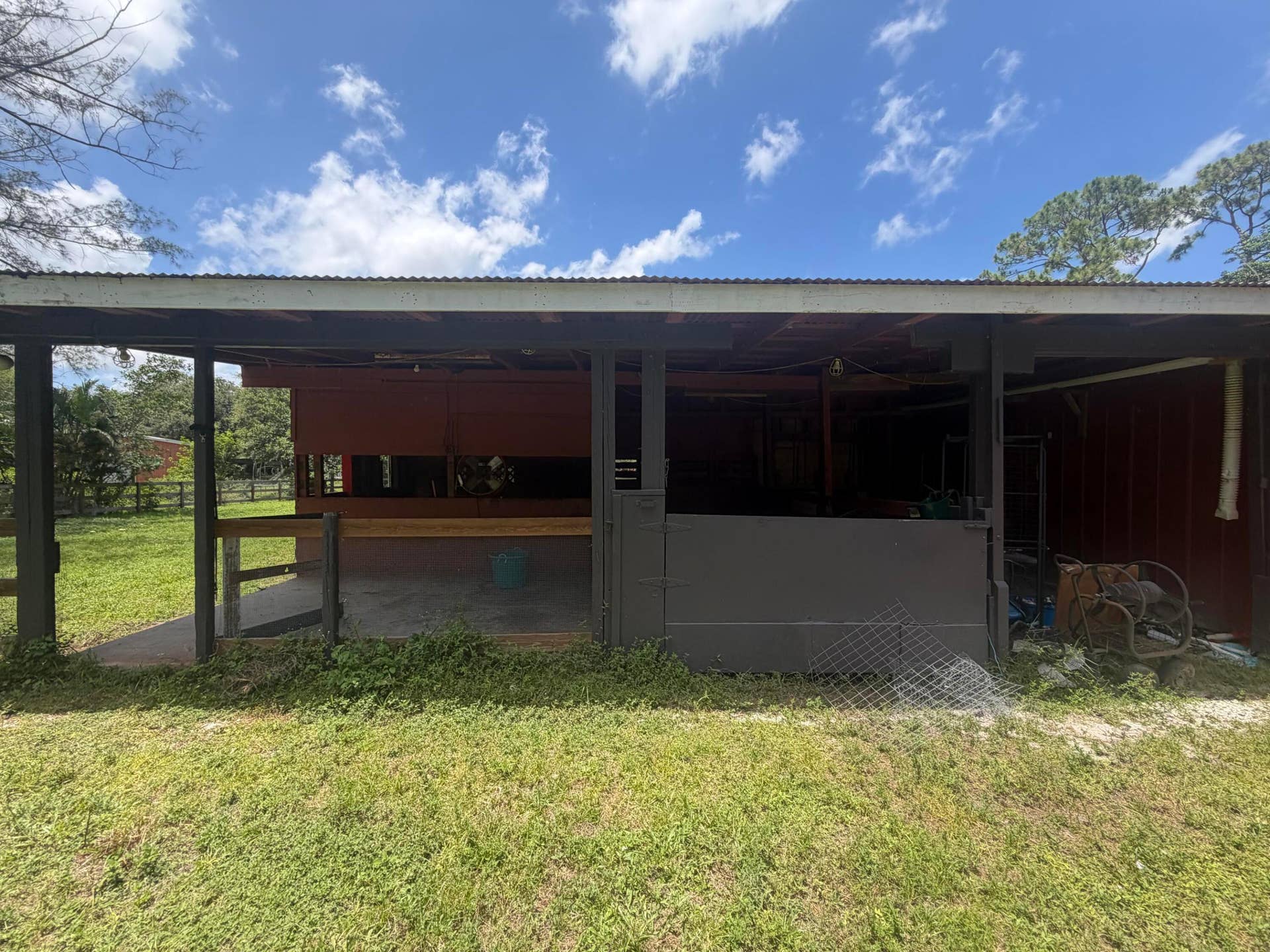 4020 Vinkemulder Road, Coconut Creek, FL 33073 Barn structure with a corrugated metal roof, red siding, and dark gray support beams