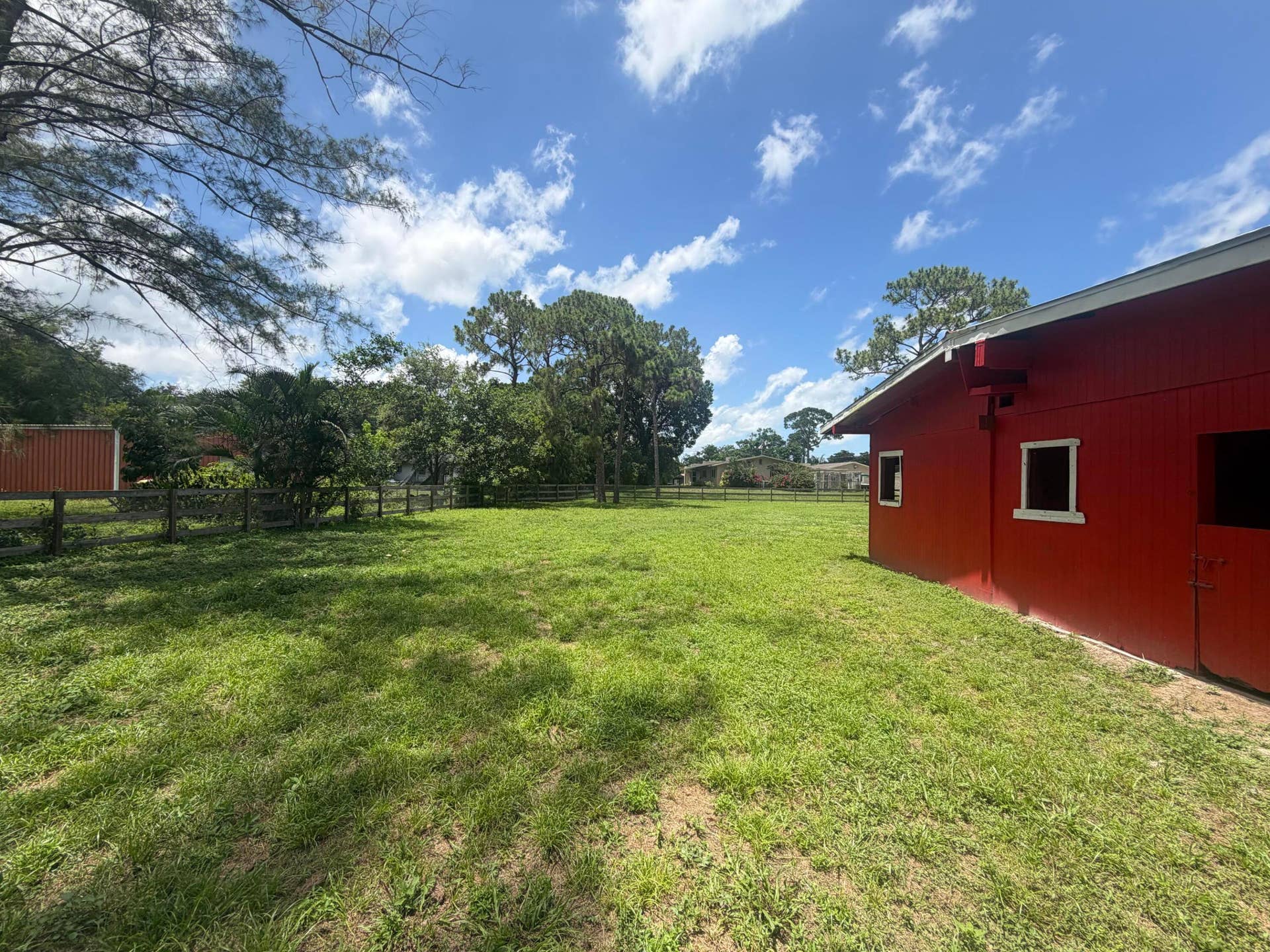 4020 Vinkemulder Road, Coconut Creek, FL 33073 Red barn structure with white trim windows and a white roofline