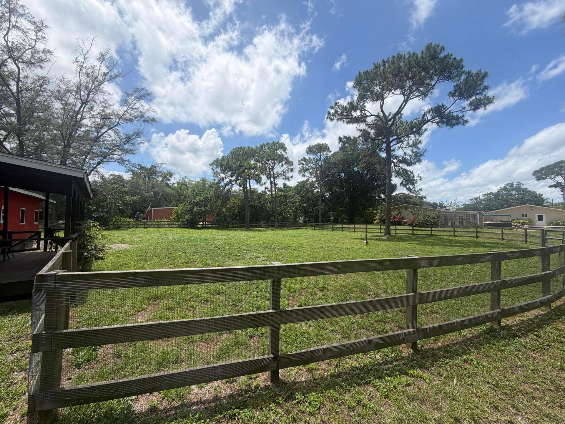 4020 Vinkemulder Road, Coconut Creek, FL 33073 Expansive grassy area with a wooden fence and mature trees