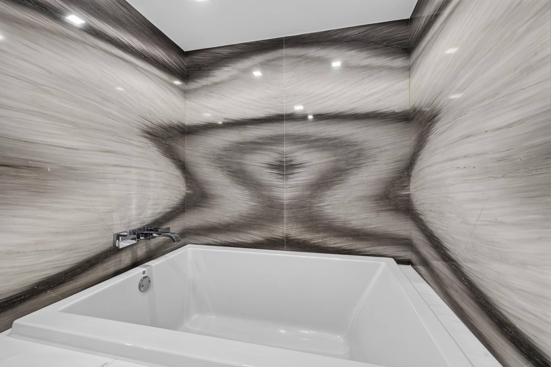 3900 Galt Ocean Drive, #2417, Fort Lauderdale, FL 33308 Relax in the deep soaking tub surrounded by dramatic book-matched stone-look walls and refined fixtures.