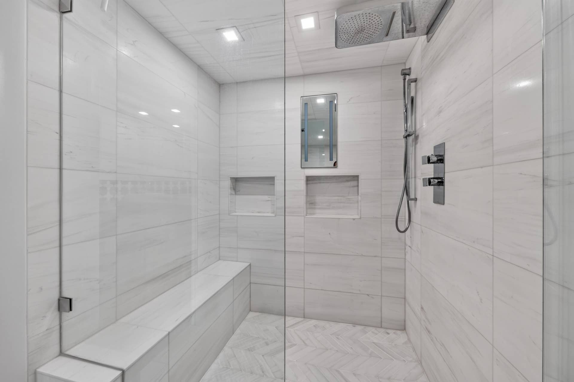 3900 Galt Ocean Drive, #2417, Fort Lauderdale, FL 33308 Oversized glass-enclosed shower featuring a built-in bench, rainfall fixture, handheld shower and recessed niches.