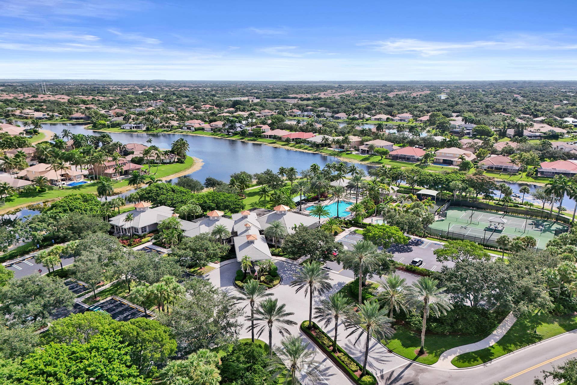 Expansive community featuring a meandering lake, tennis courts, and a swimming pool