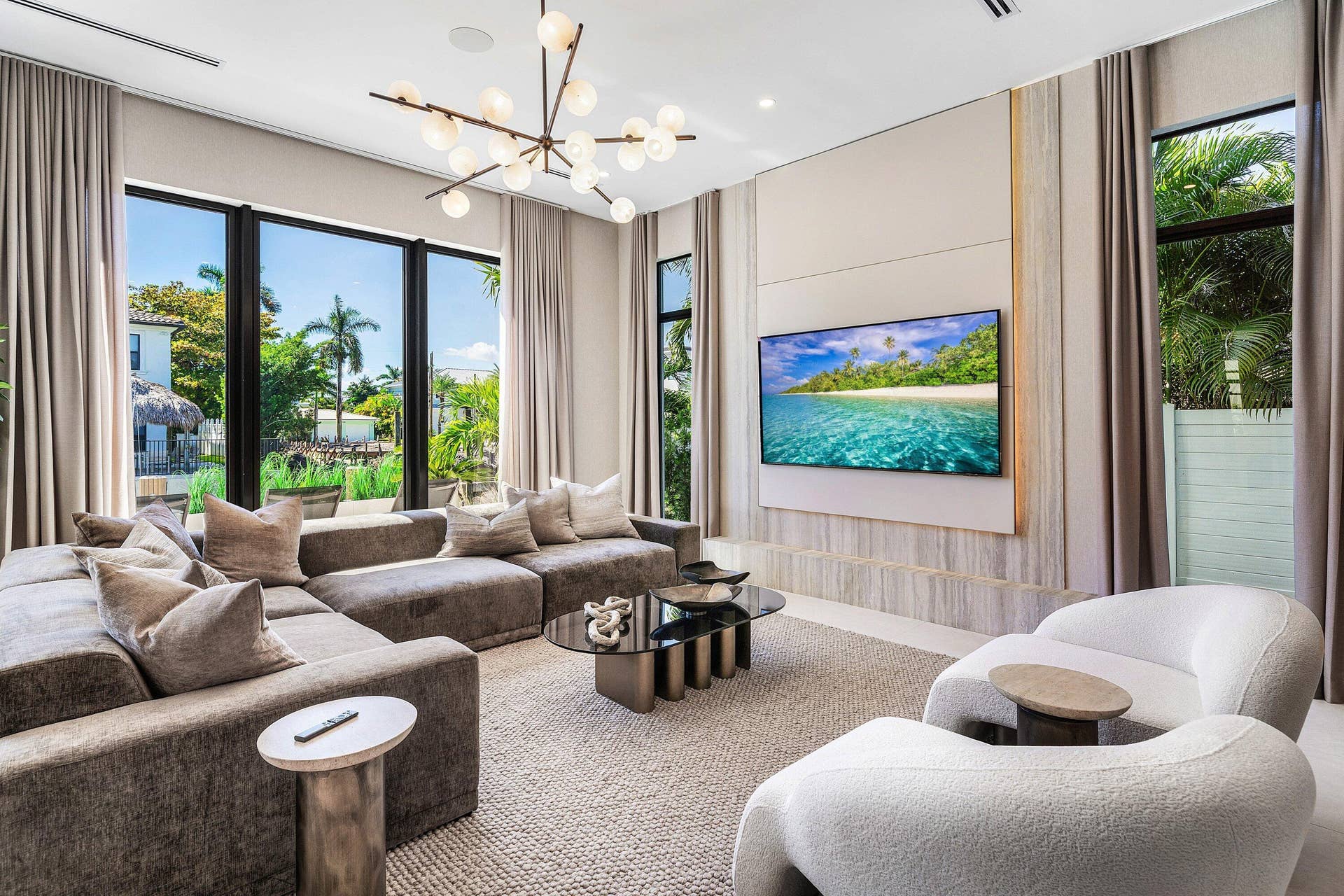 Integrated media wall with built-in cabinetry, large format television, and accent lighting