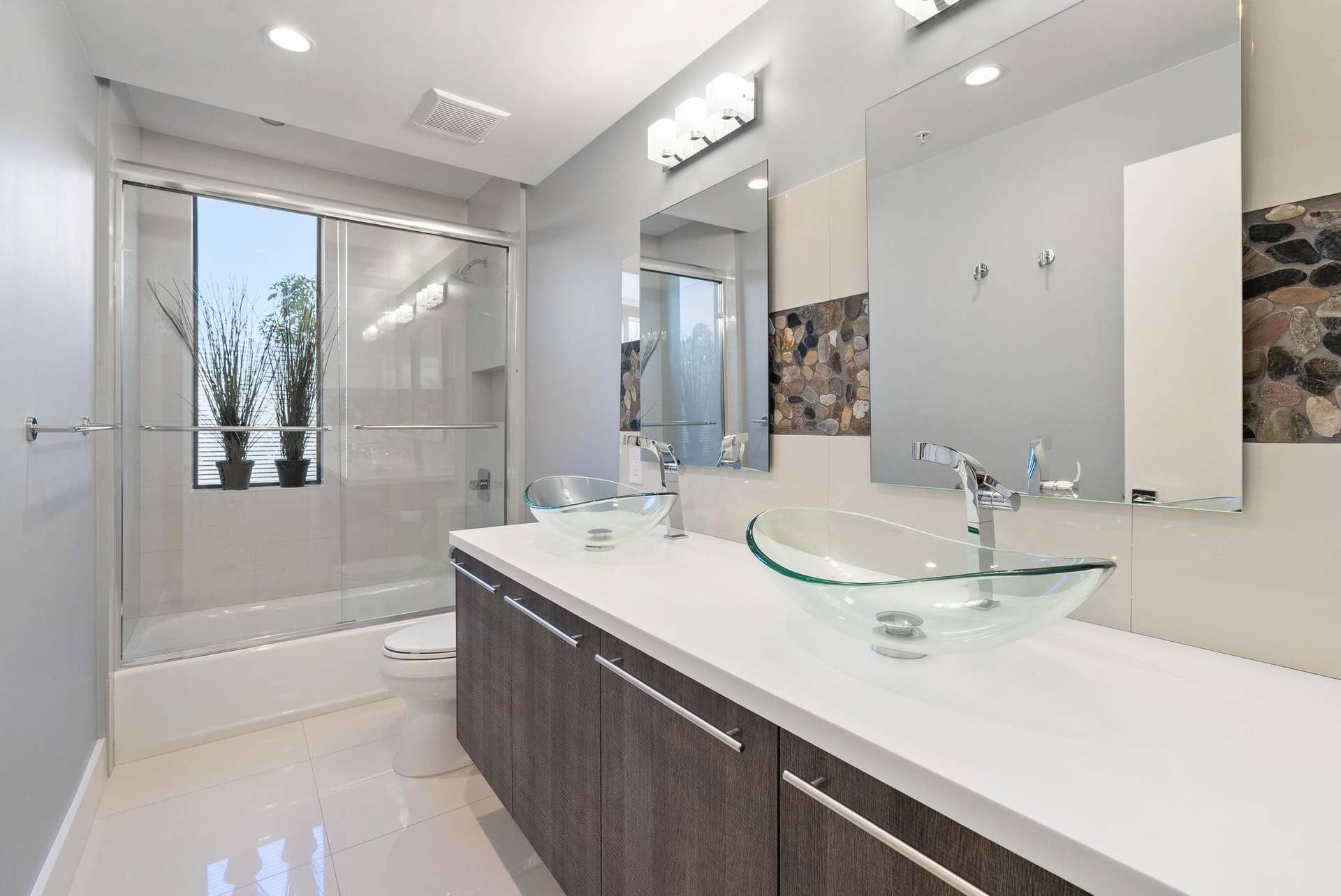 180 SE 4TH Terrace, Pompano Beach, Pompano Beach, FL 33060 The guest bath has glass shower doors and loads of storage with floating cabinets