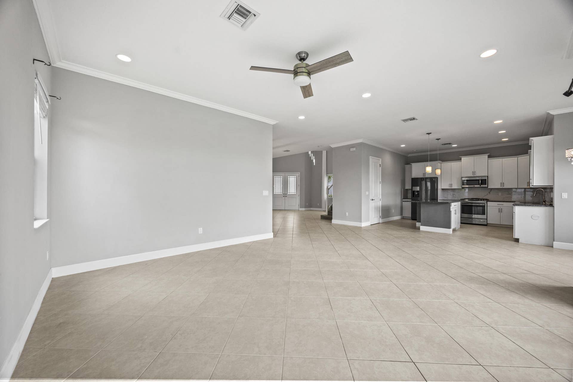 16007 Whippoorwill Circle, Westlake, Westlake, FL 33470 Expansive open-concept living area featuring tile flooring, recessed lighting, and a ceiling fan