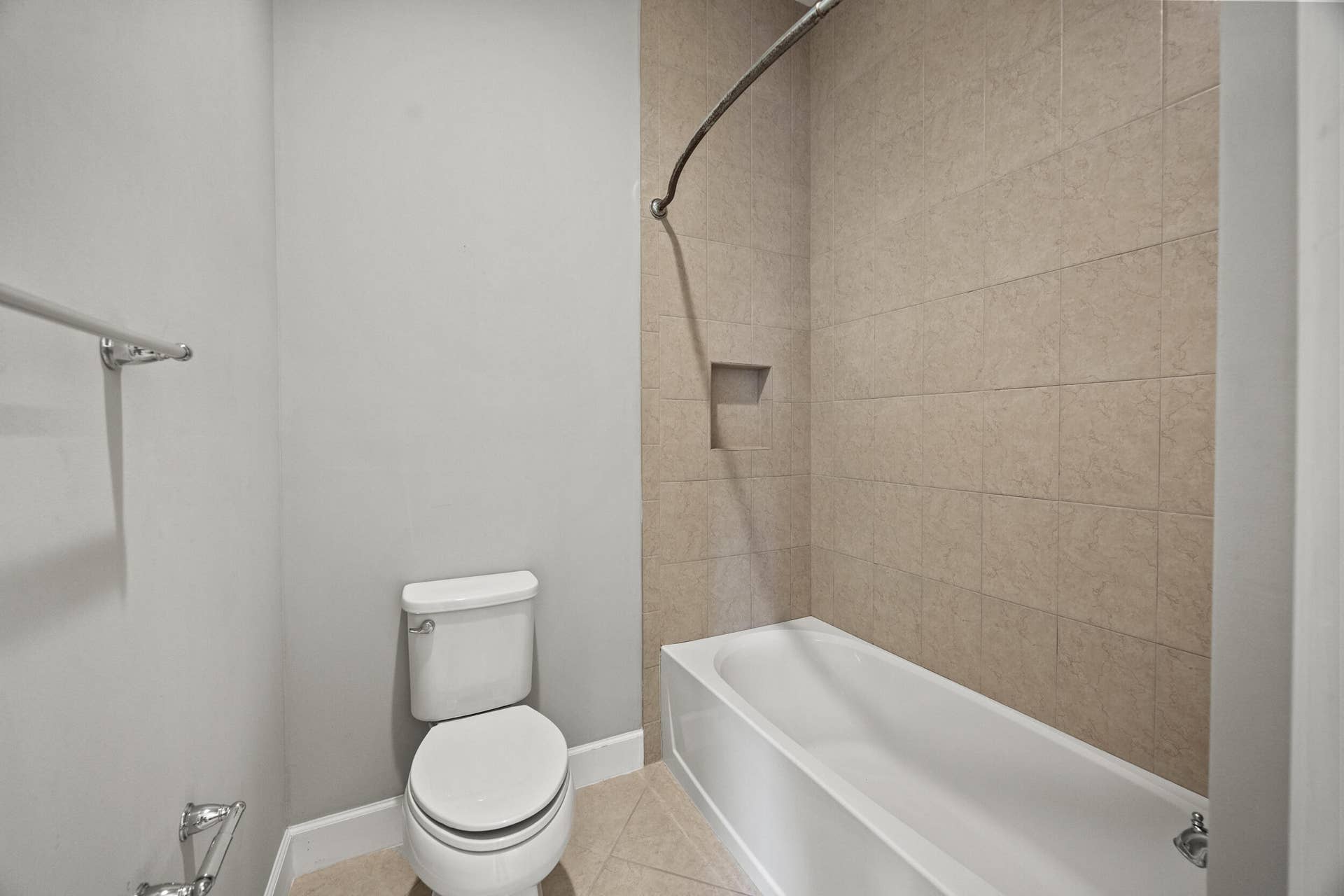 16007 Whippoorwill Circle, Westlake, Westlake, FL 33470 Bathtub with integrated shower, tiled walls, recessed shower niche, and floor-mounted toilet