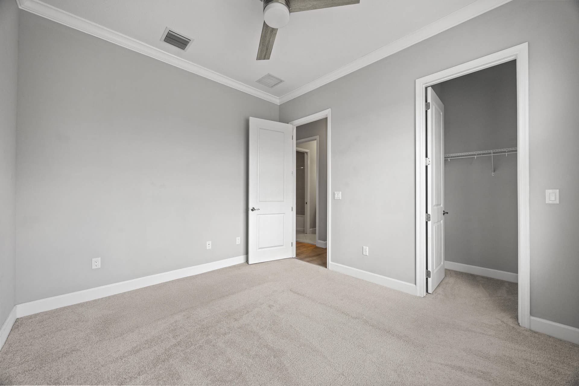 16007 Whippoorwill Circle, Westlake, Westlake, FL 33470 Plush carpeting, crown molding, ceiling fan, and white trim work