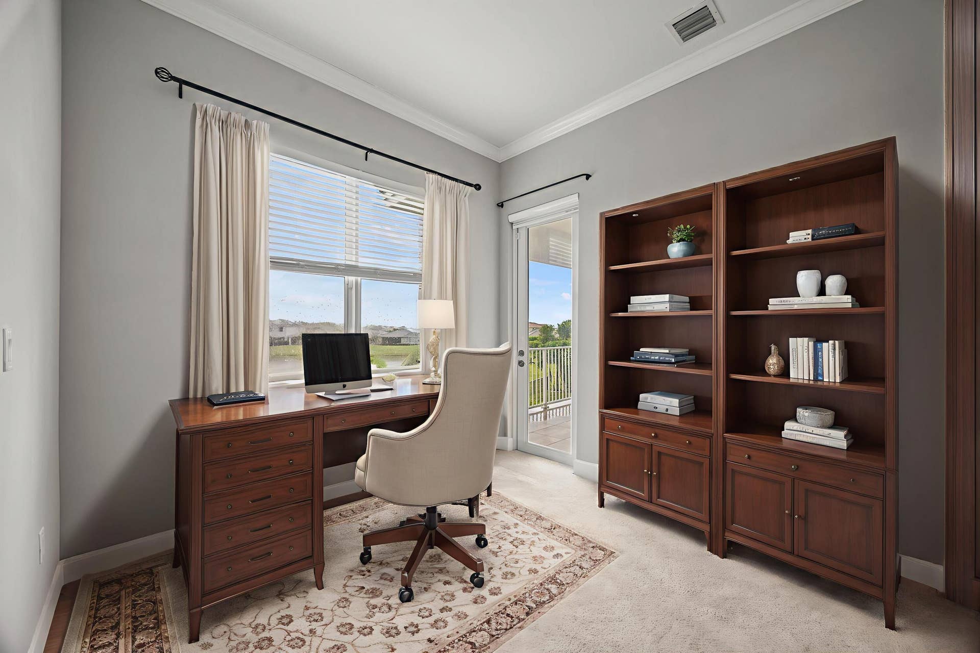 16007 Whippoorwill Circle, Westlake, Westlake, FL 33470 Built-in wood-finish bookcases, crown molding, and a sliding glass door providing natural light