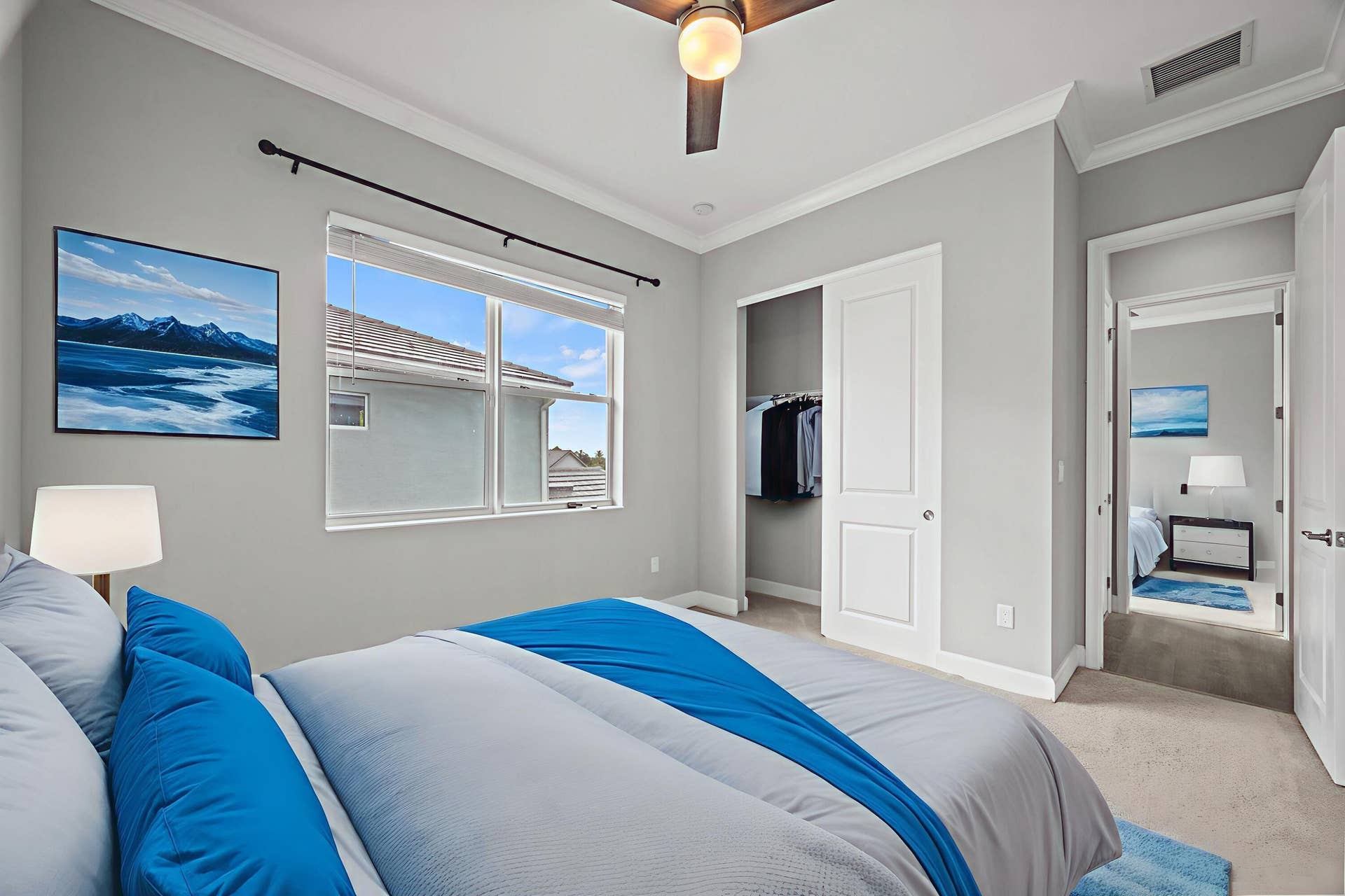 16007 Whippoorwill Circle, Westlake, Westlake, FL 33470 Recessed window with blinds, ceiling fan with integrated lighting, built-in closet with sliding panel doors, and neutral wall paint