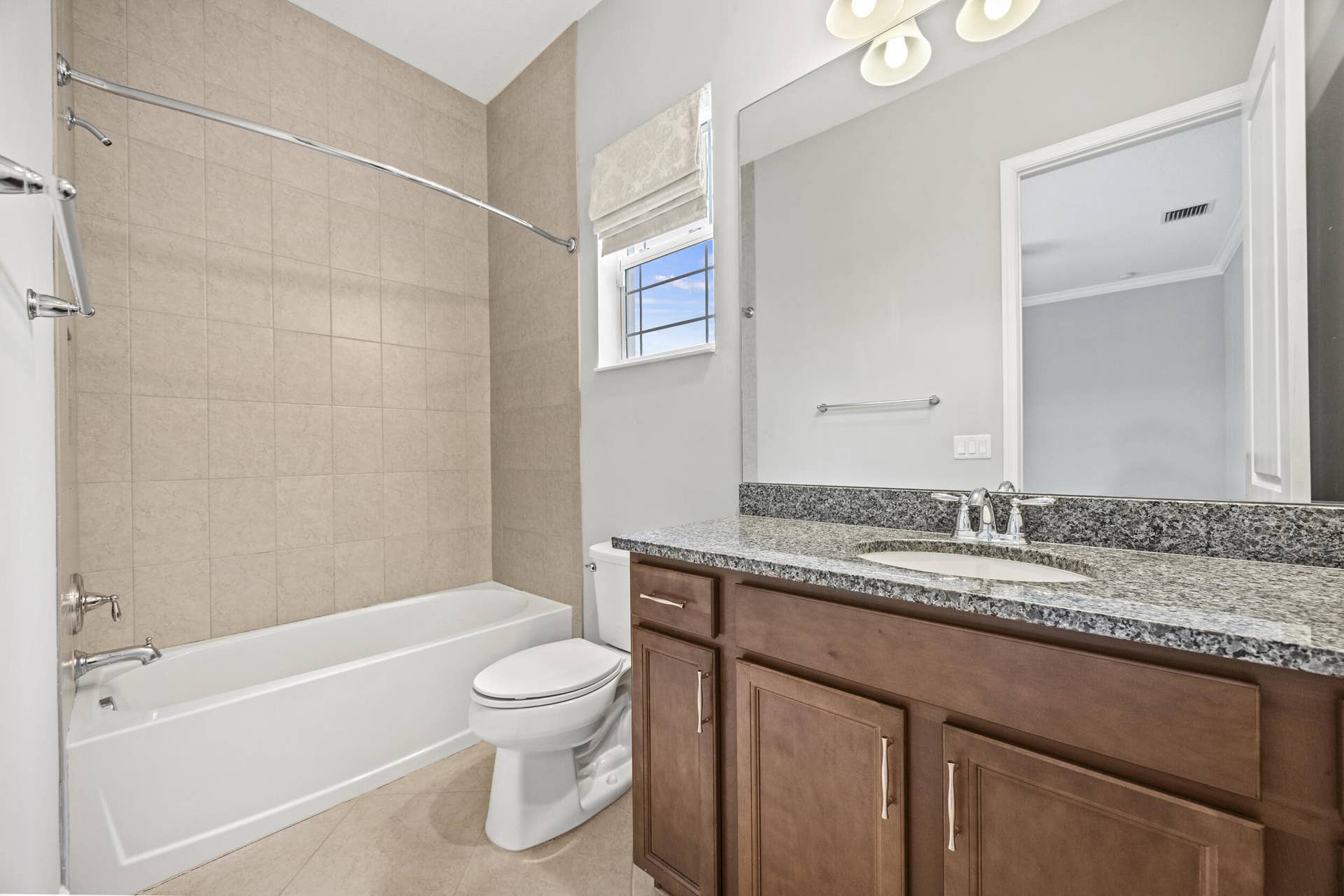 16007 Whippoorwill Circle, Westlake, Westlake, FL 33470 Bathroom featuring a wood-finish vanity with granite countertop, integrated sink, and chrome fixtures