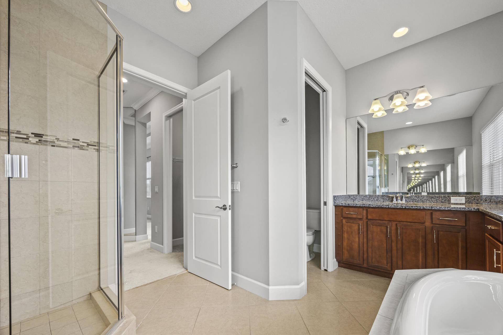 16007 Whippoorwill Circle, Westlake, Westlake, FL 33470 Glass-enclosed shower with tiled walls and decorative accent band