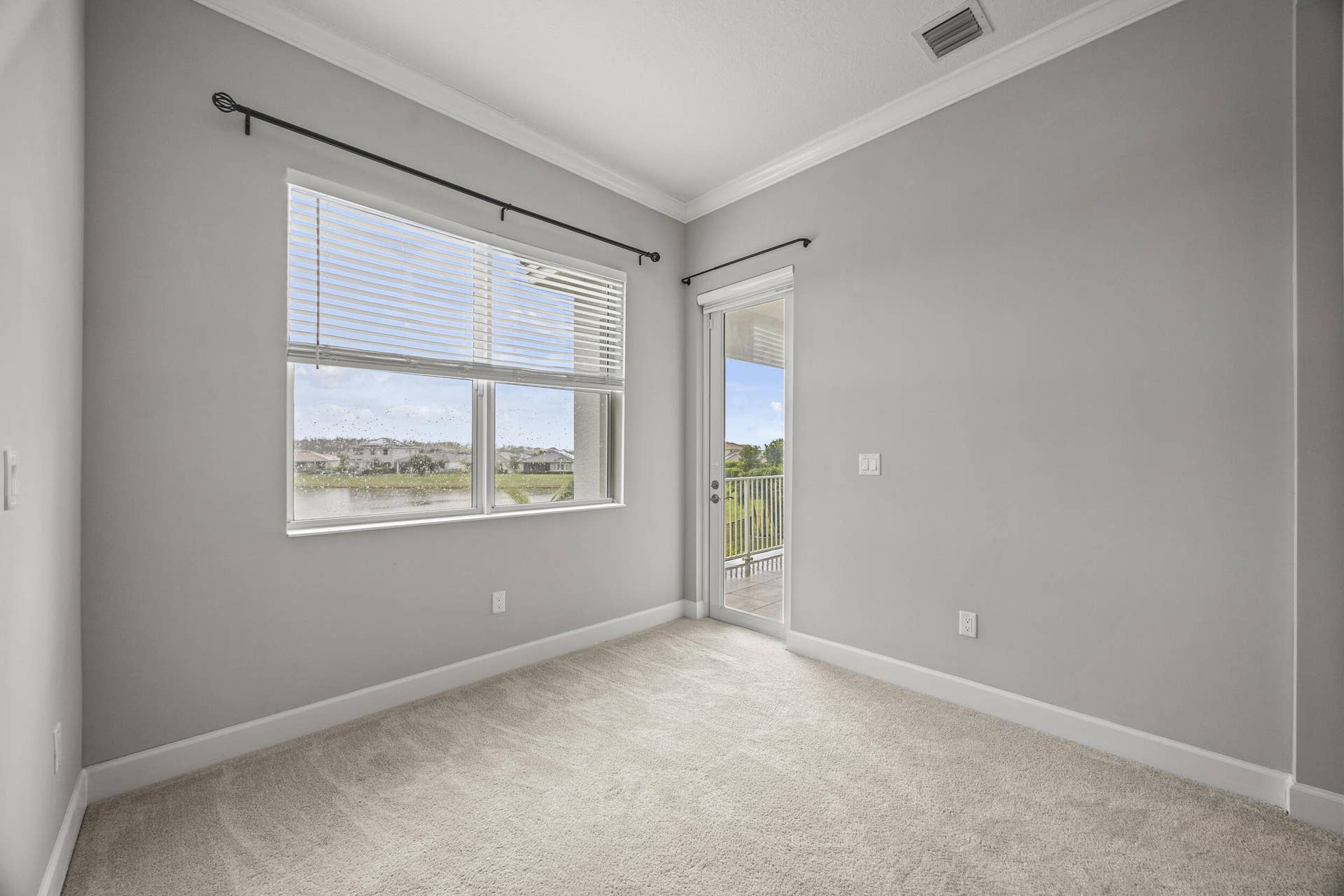 16007 Whippoorwill Circle, Westlake, Westlake, FL 33470 Wall-to-wall carpeting, crown molding, and a sliding glass door to a private balcony
