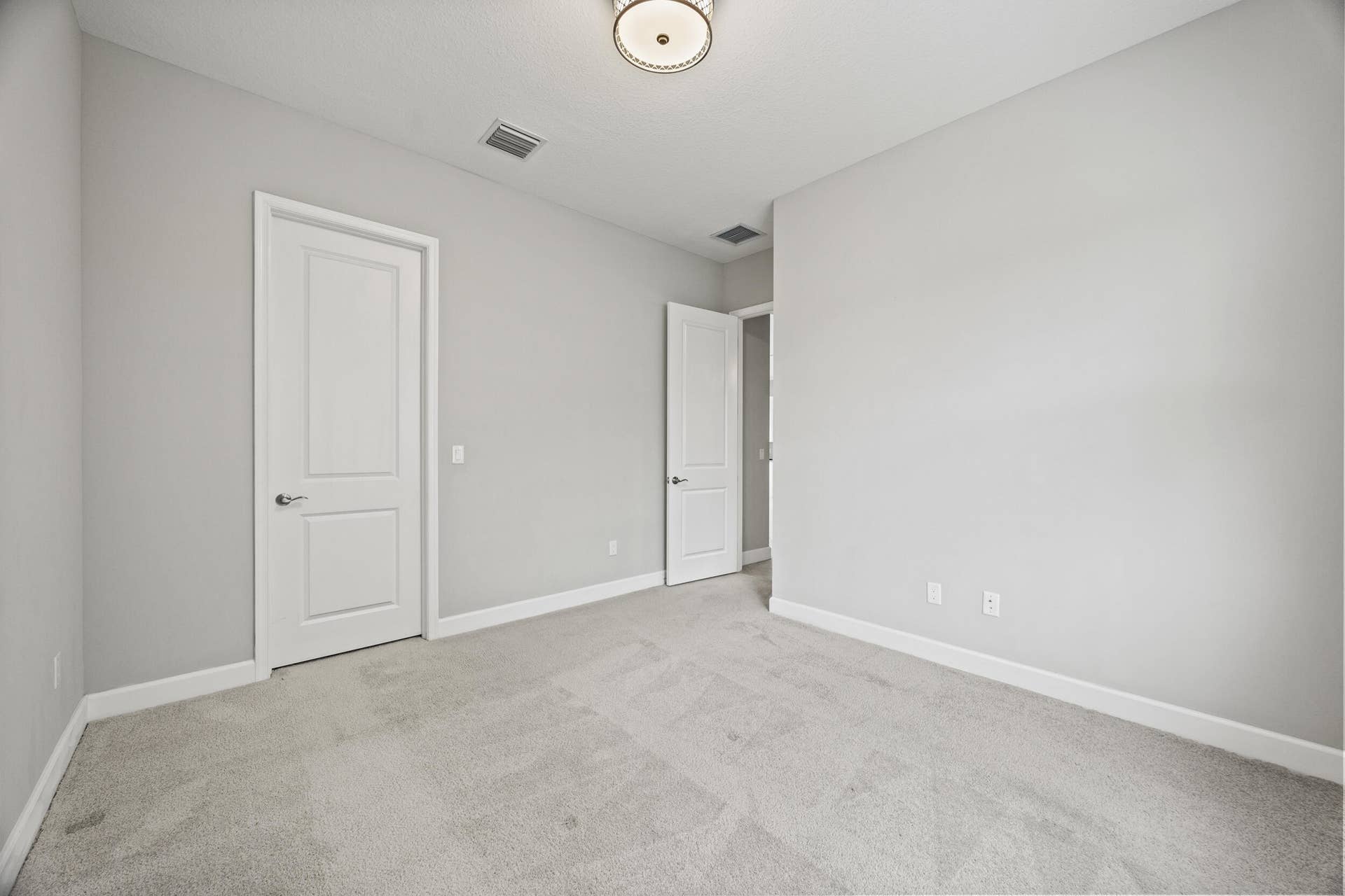 16007 Whippoorwill Circle, Westlake, Westlake, FL 33470 Neutral-toned walls, plush carpeting, and a flush mount ceiling light fixture