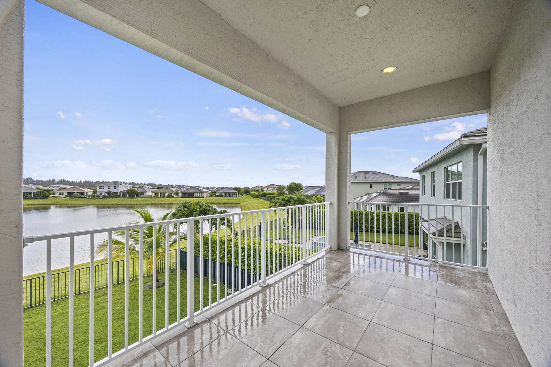 16007 Whippoorwill Circle, Westlake, Westlake, FL 33470 Covered balcony featuring tile flooring and white railings