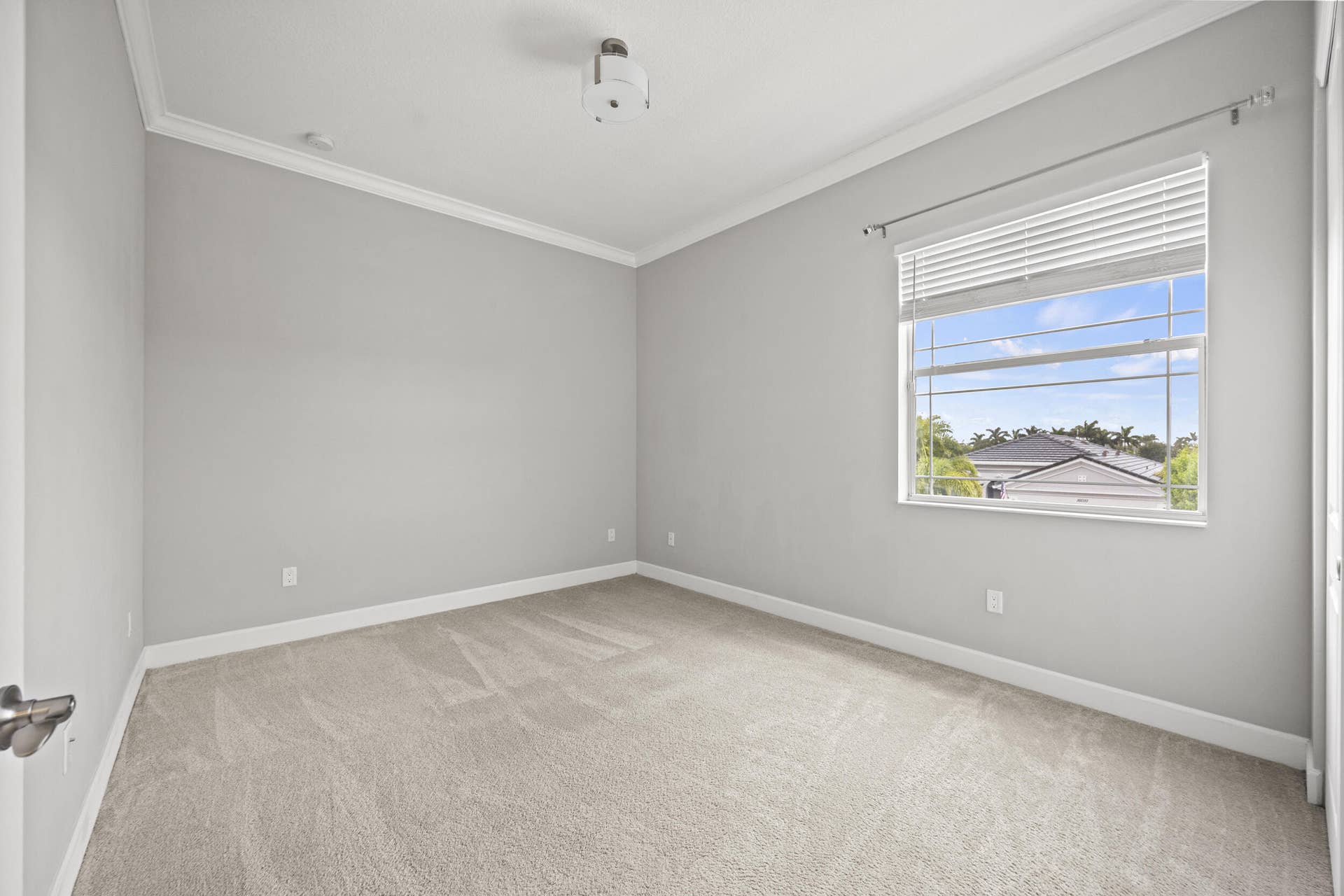 16007 Whippoorwill Circle, Westlake, Westlake, FL 33470 Neutral wall color, crown molding, light-colored carpeting, and a window with horizontal blinds