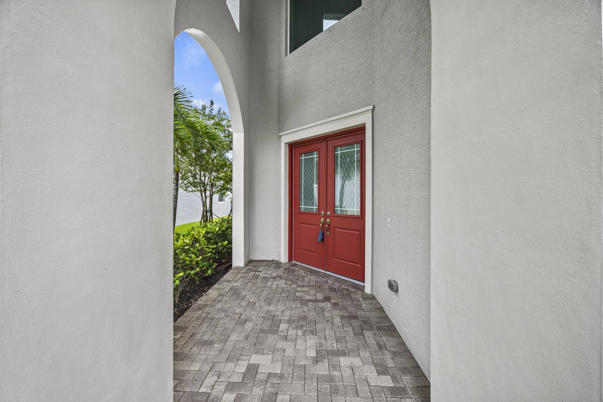 16007 Whippoorwill Circle, Westlake, Westlake, FL 33470 Textured exterior walls with an arched entryway