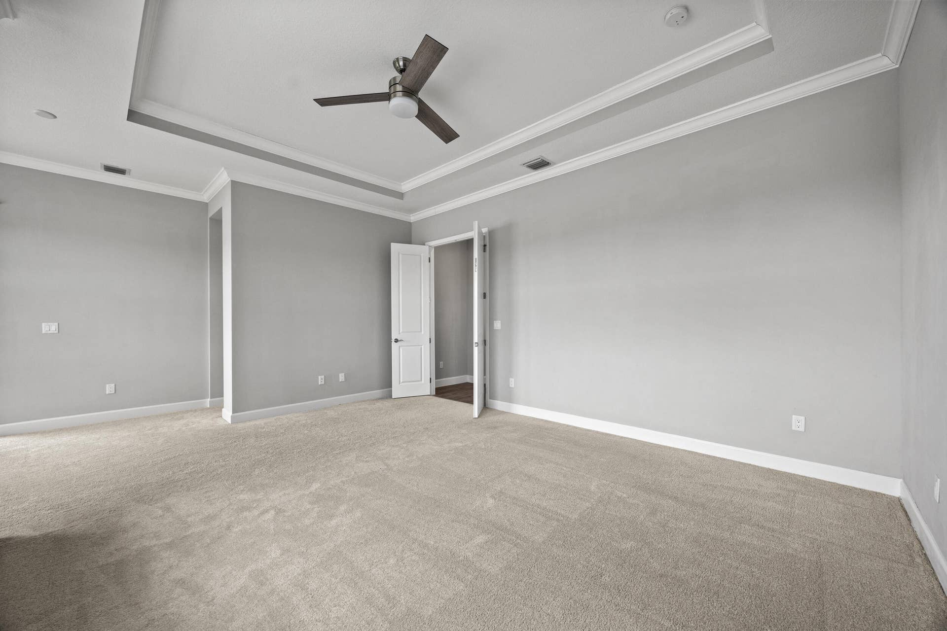 16007 Whippoorwill Circle, Westlake, Westlake, FL 33470 Tray ceiling with crown molding, ceiling fan, and light gray wall paint