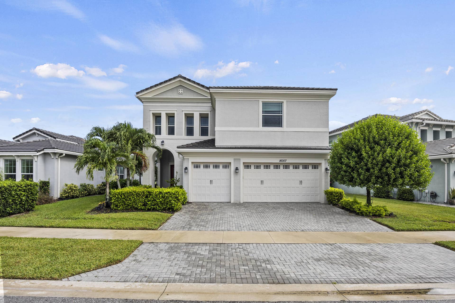16007 Whippoorwill Circle, Westlake, Westlake, FL 33470 Modern two-story residence featuring a clean-lined architectural design with a gabled roofline and columned entry