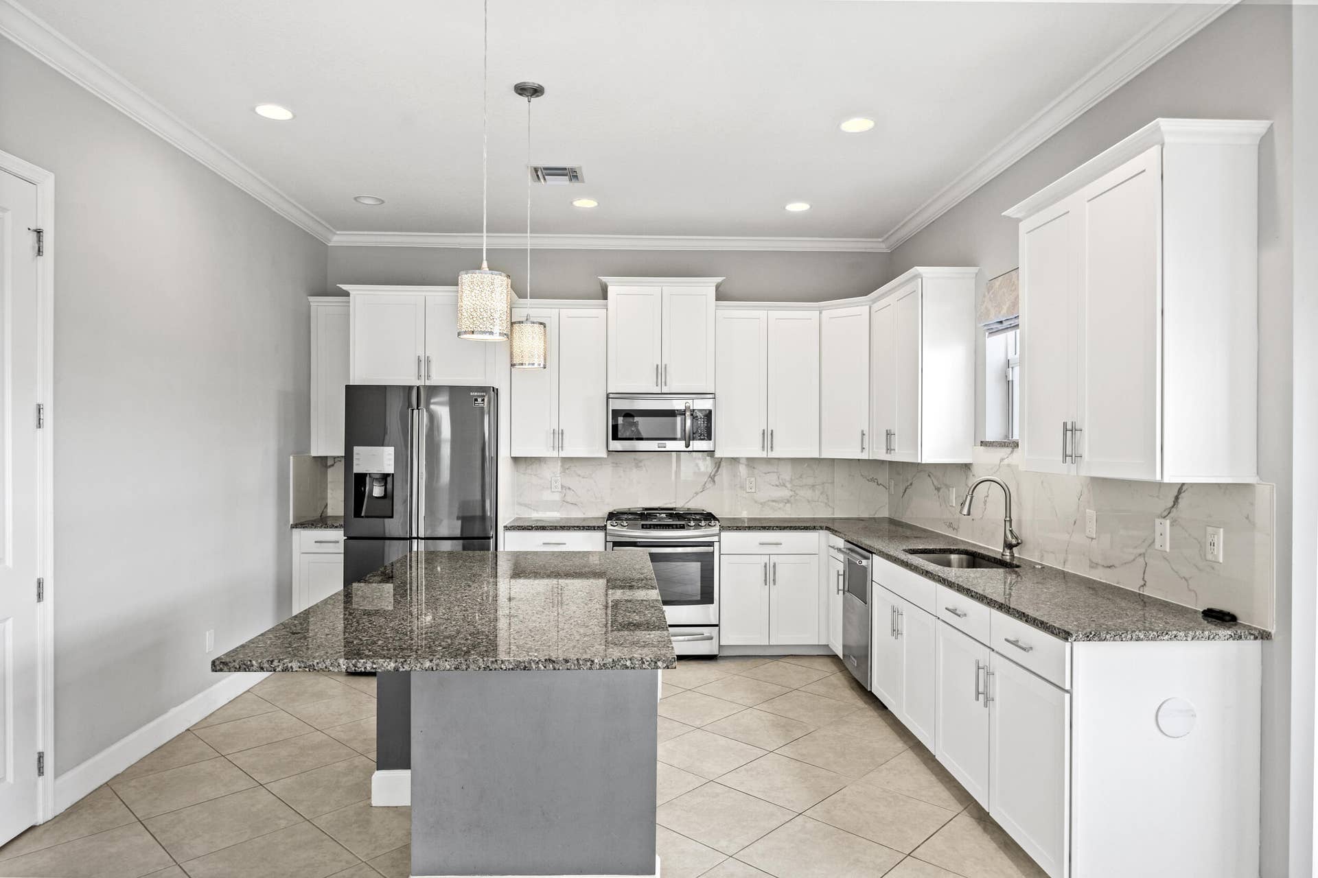 16007 Whippoorwill Circle, Westlake, Westlake, FL 33470 Kitchen featuring white cabinetry, granite countertops, tile flooring, stainless steel appliances, and pendant lighting