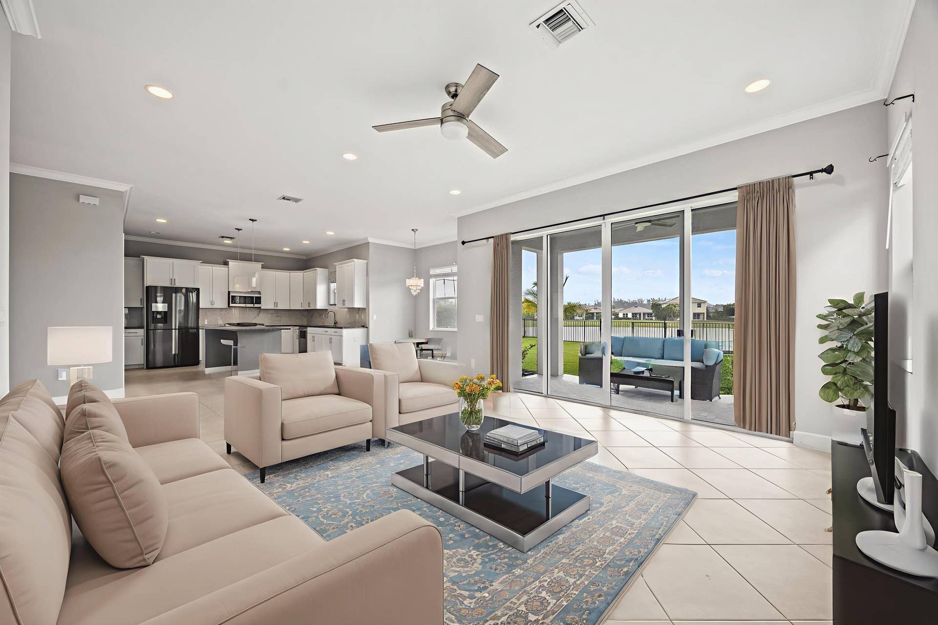 16007 Whippoorwill Circle, Westlake, Westlake, FL 33470 Spacious open-concept living area featuring large format tile flooring, crown molding, and recessed lighting