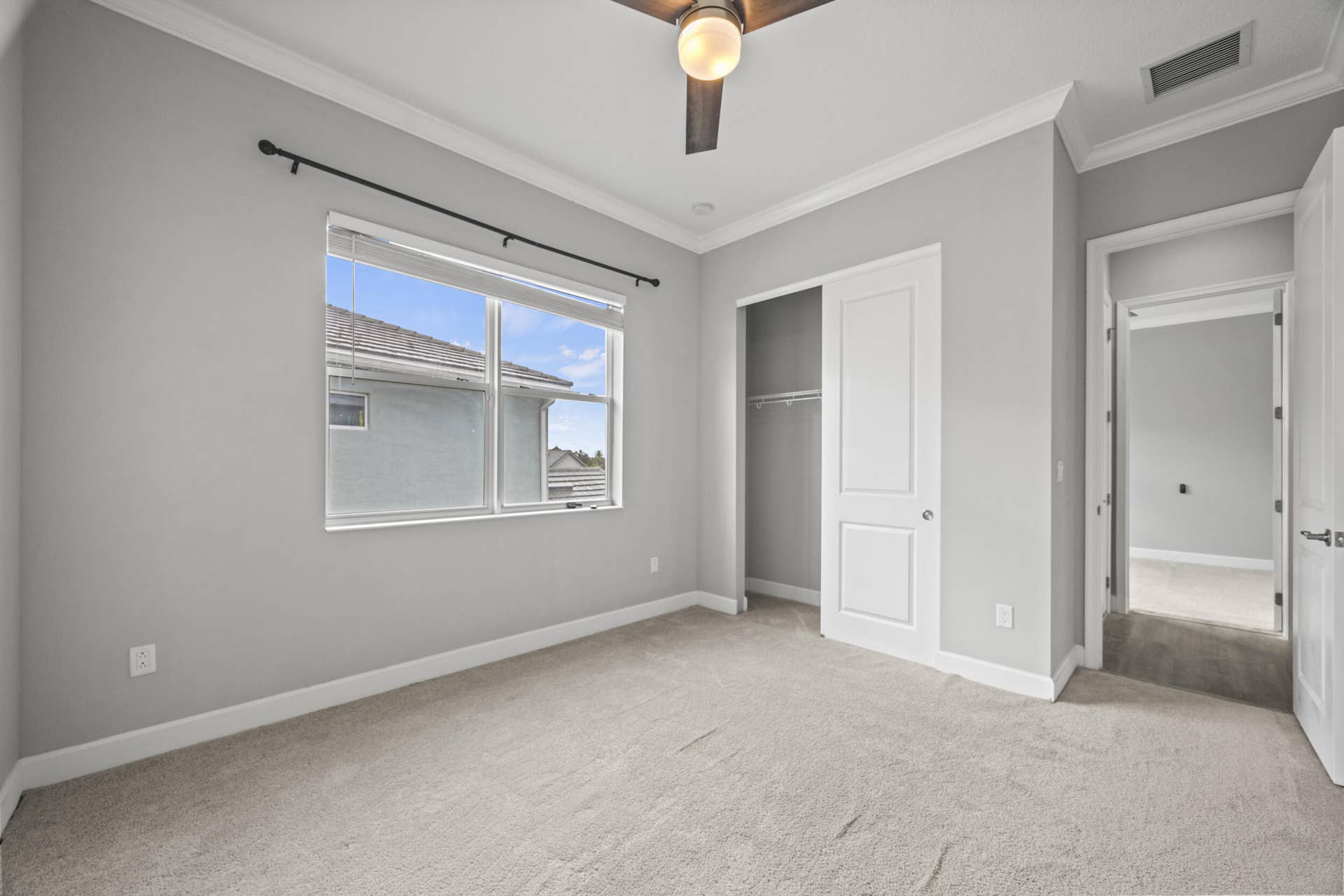 16007 Whippoorwill Circle, Westlake, Westlake, FL 33470 Carpeted room with a ceiling fan, crown molding, double-paned window, and a sliding closet door