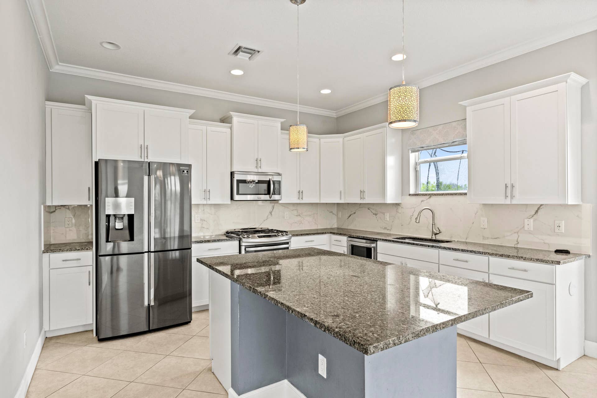 16007 Whippoorwill Circle, Westlake, Westlake, FL 33470 Kitchen featuring white cabinetry, stainless steel appliances, granite countertops, and a central island