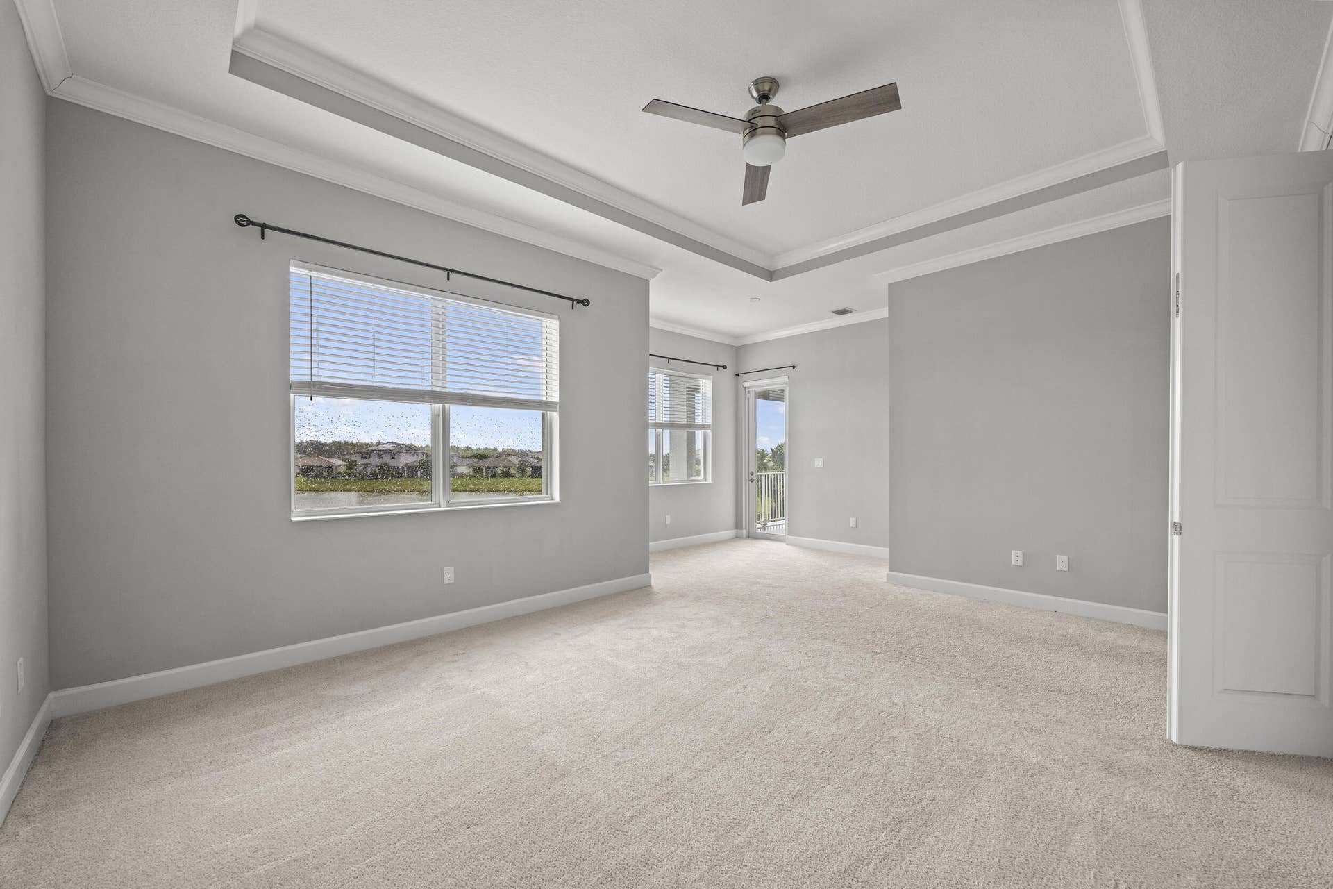 16007 Whippoorwill Circle, Westlake, Westlake, FL 33470 Expansive room with neutral carpeting, tray ceiling, and ceiling fan