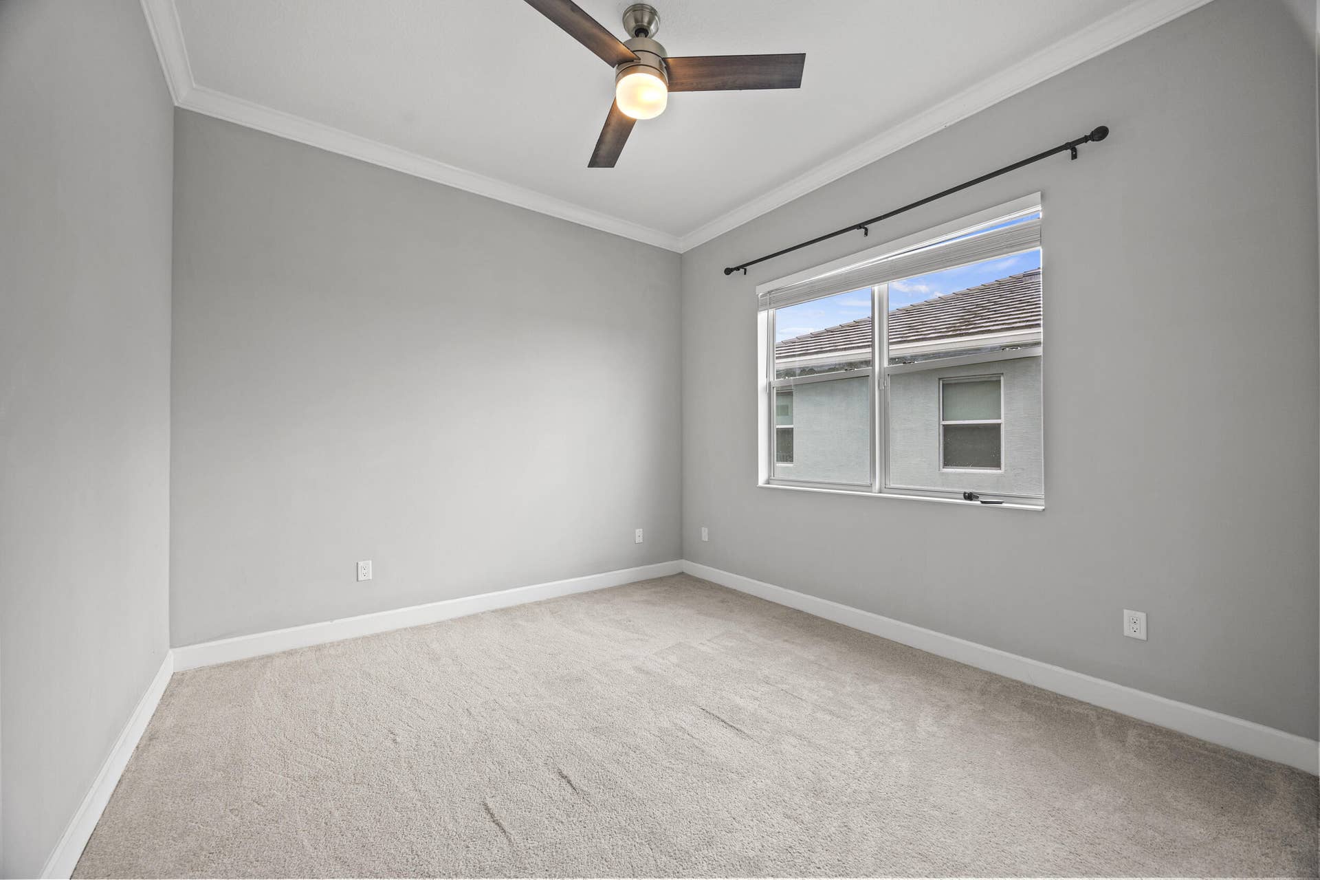 16007 Whippoorwill Circle, Westlake, Westlake, FL 33470 Recessed lighting, crown molding, gray painted walls, window with roller shade, and ceiling fan with light fixture