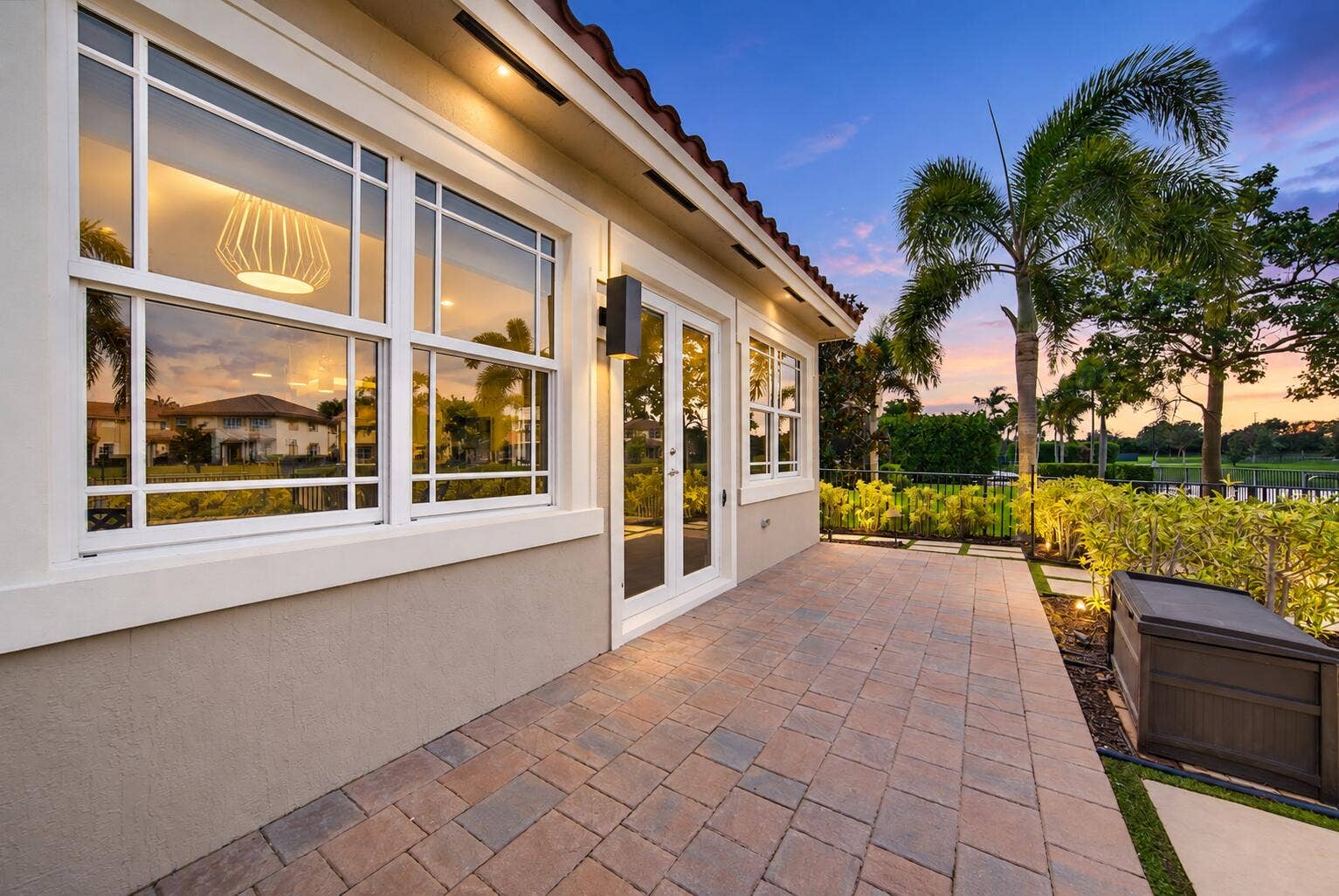 8561 LAKESIDE Bend, Parkland, FL 33076 Twilight Patio with Palm-Lined Views