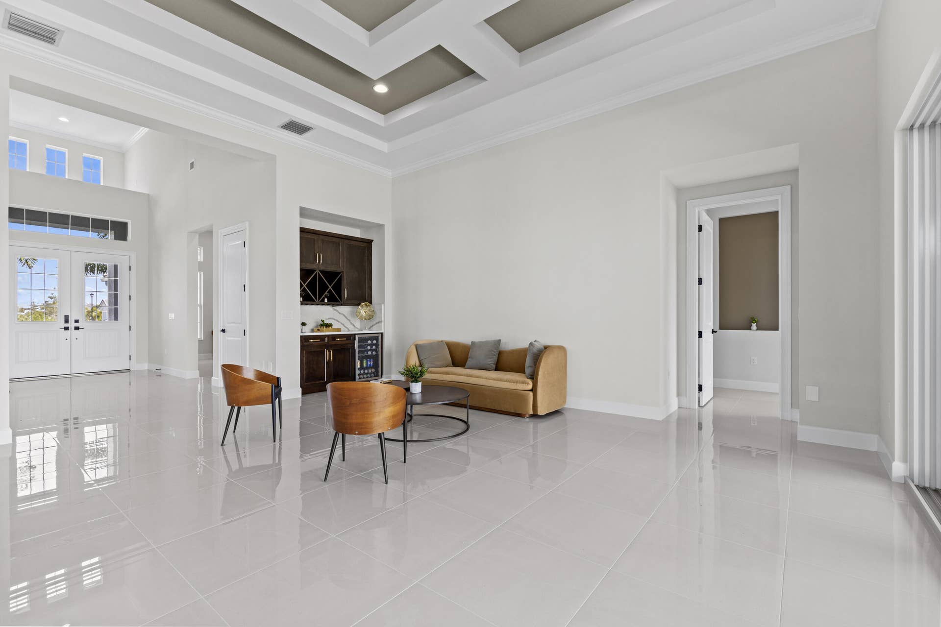 14976 Woodlot Court, Westlake, FL 33470 Expansive living area with high ceilings, large format tile flooring, and a coffered ceiling