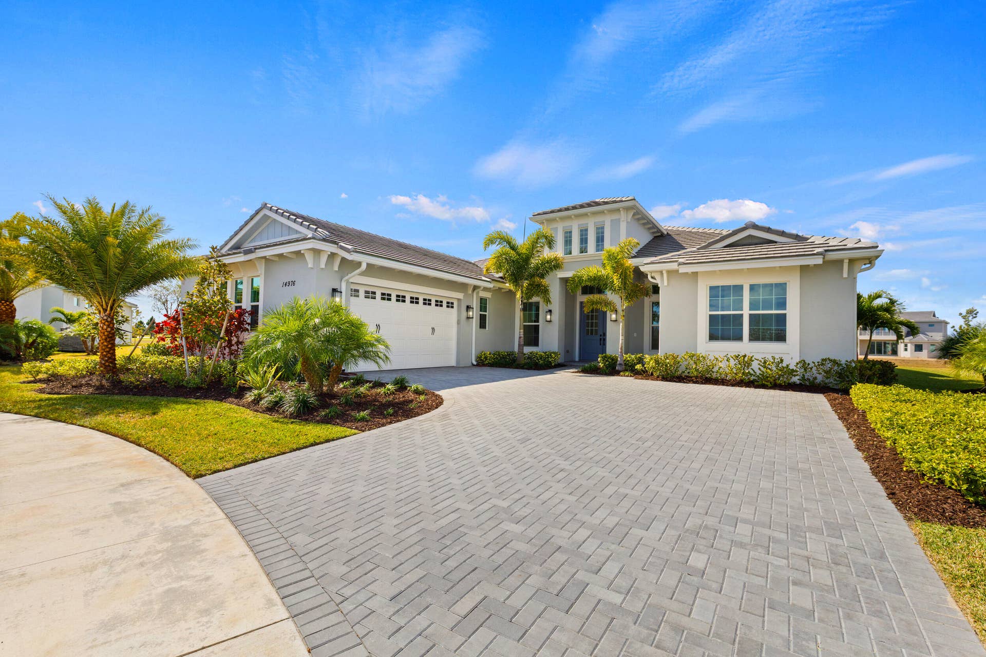 14976 Woodlot Court, Westlake, FL 33470 Contemporary exterior with a multi-gabled roofline and a large paver driveway